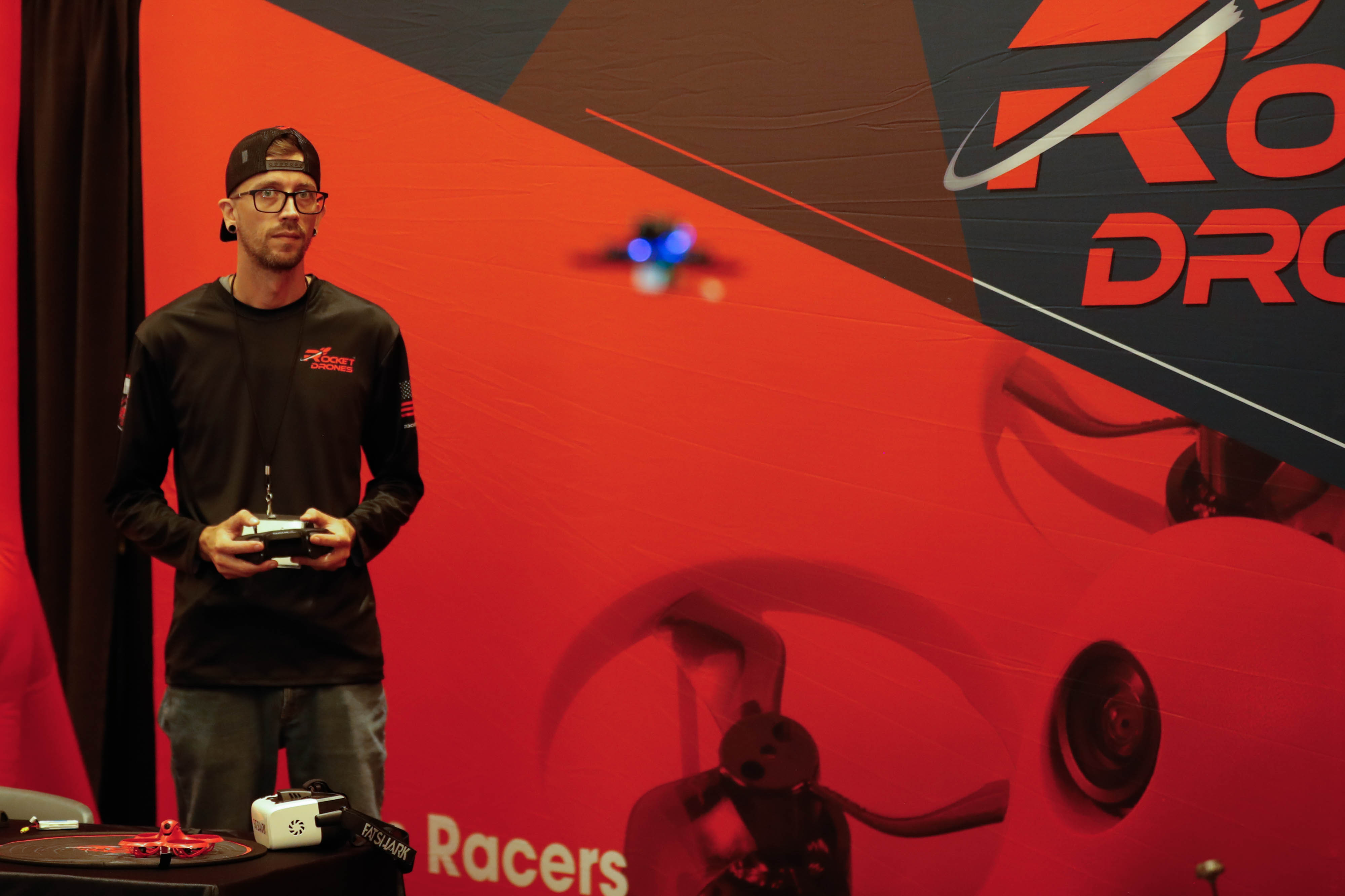 Chantry Holdman with Rocket Drones demonstrates flying a drone in the exhibit hall. Photo by Rebecca Boone.