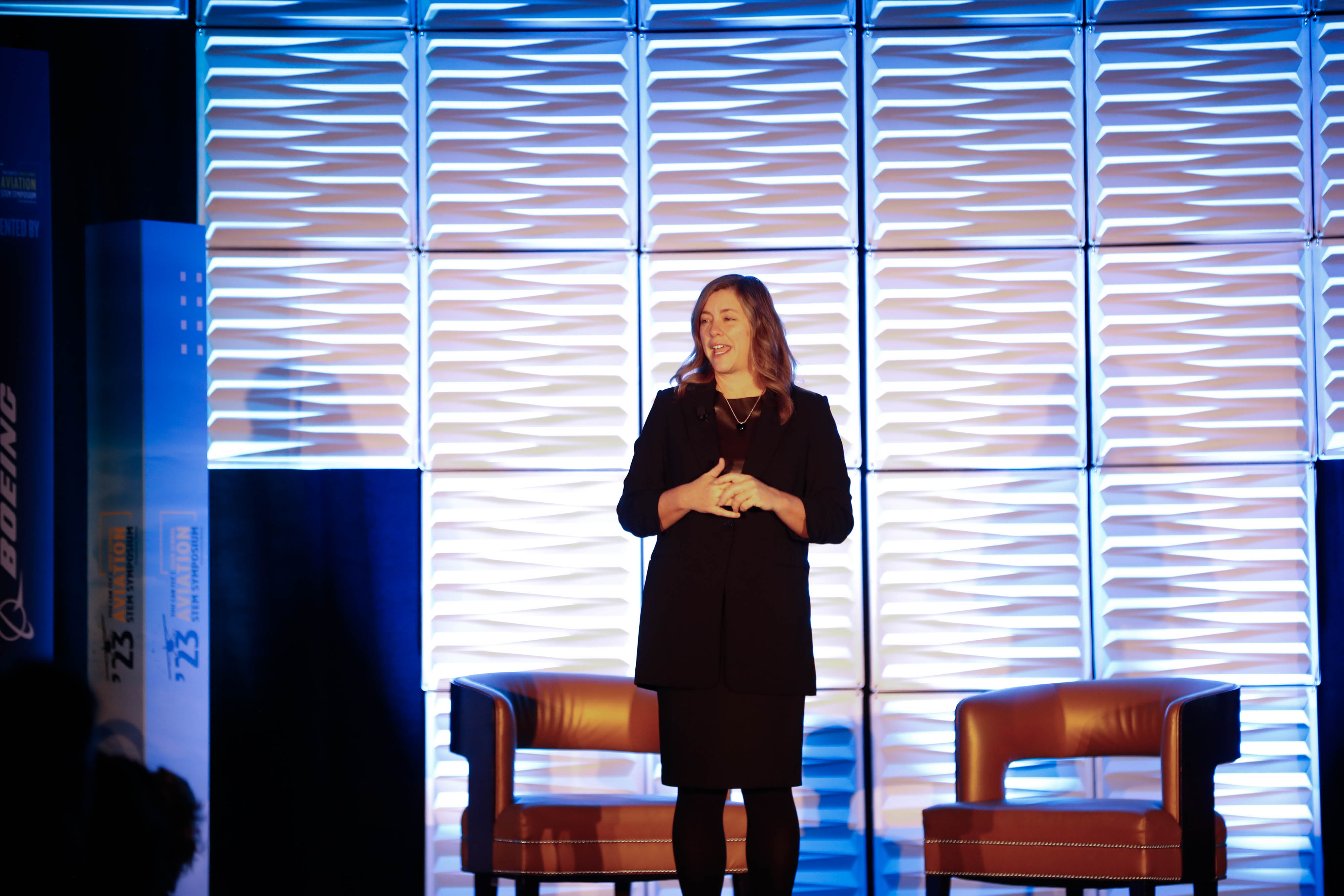 Joey Colleran of Boeing Global Services greets symposium attendees during the opening general session on November 13. Photo by Rebecca Boone.