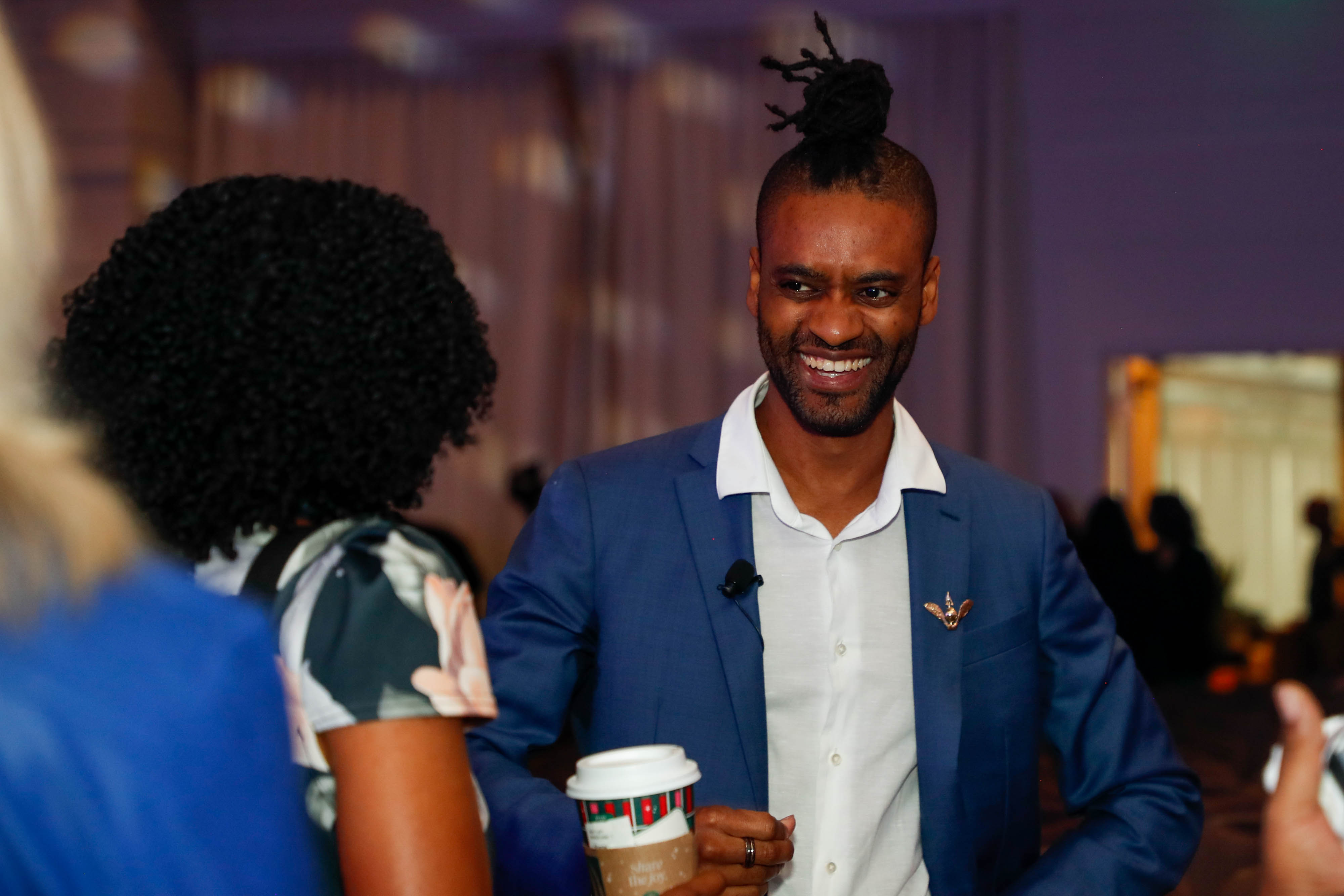 Keynote speaker Christopher "Chuie" Huie, senior manager of business insights for Virgin Galactic and co-founder of Black Leaders in Aerospace Scholarship and Training, speaks with Shauntel Clarke from Embry-Riddle Aeronautical University after his speech. Photo by Rebecca Boone.