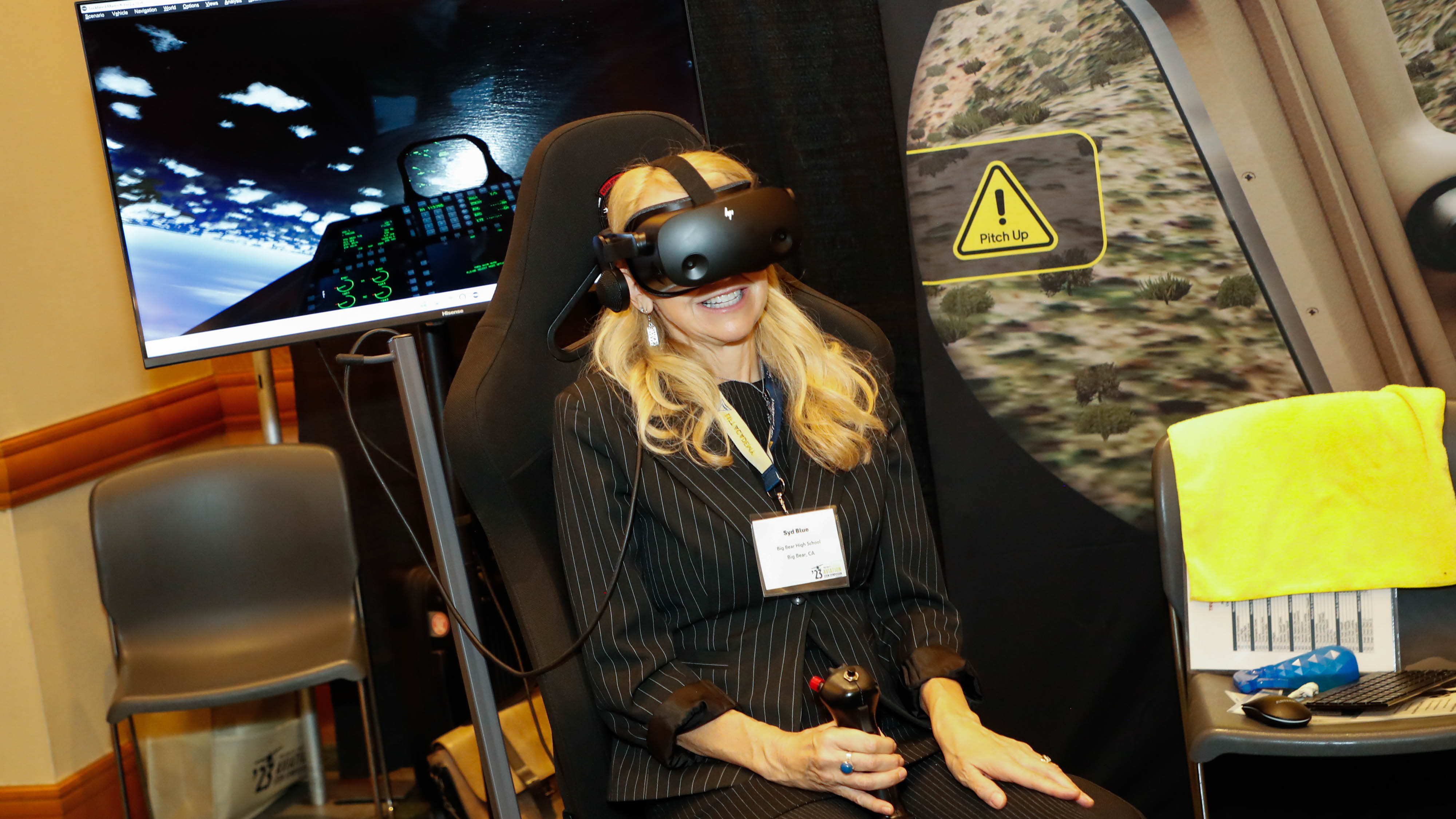 Syd Blue from Big Bear High School in Big Bear City, California, tests a simulator in the True Course Simulations booth in the exhibit hall. Photo by Rebecca Boone.