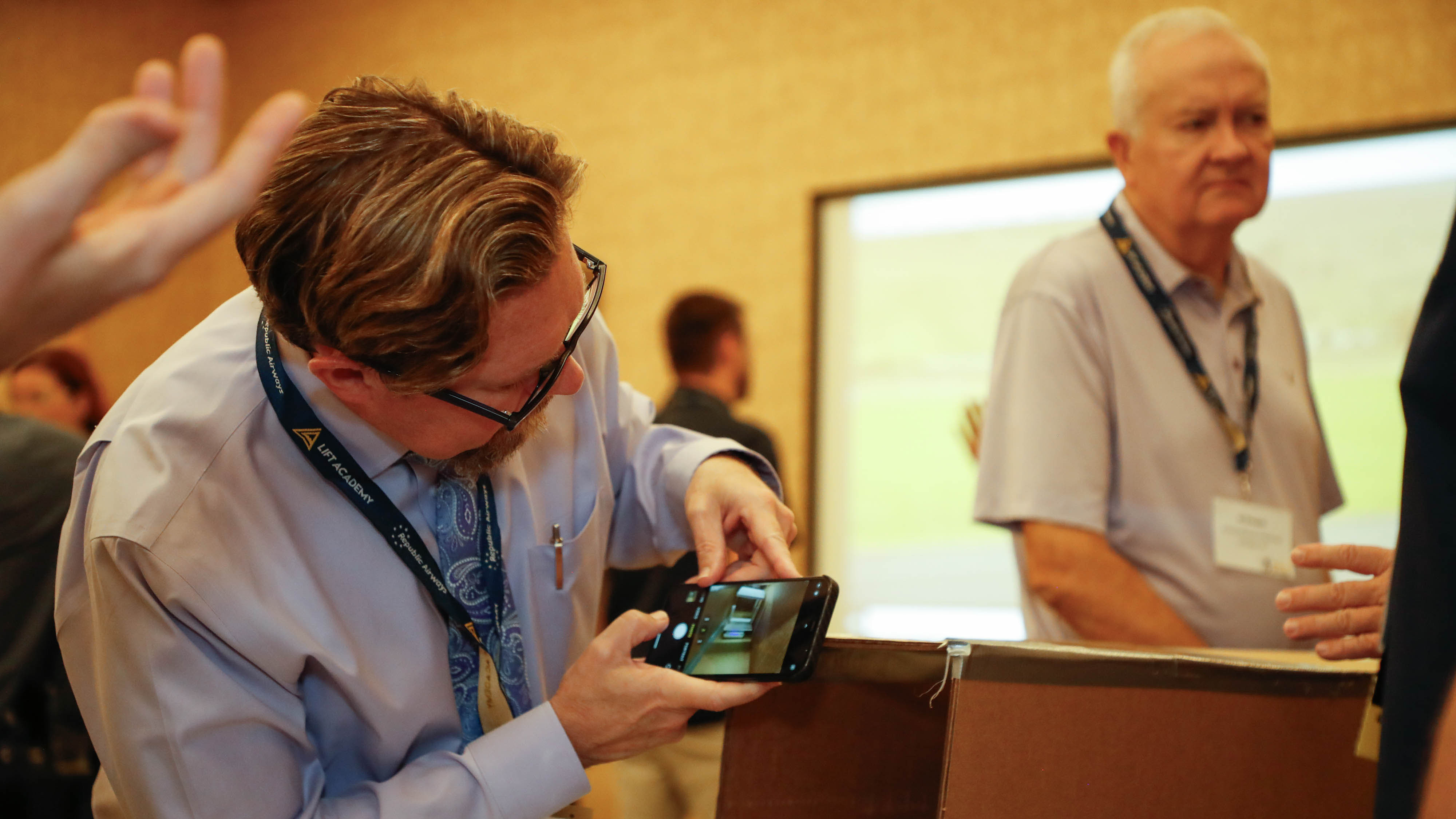 Thomas Ellis from Palm Beach Day Academy in Palm Beach, Florida, snaps a photo of a wind tunnel display during a hands-on workshop. Photo by Rebecca Boone.