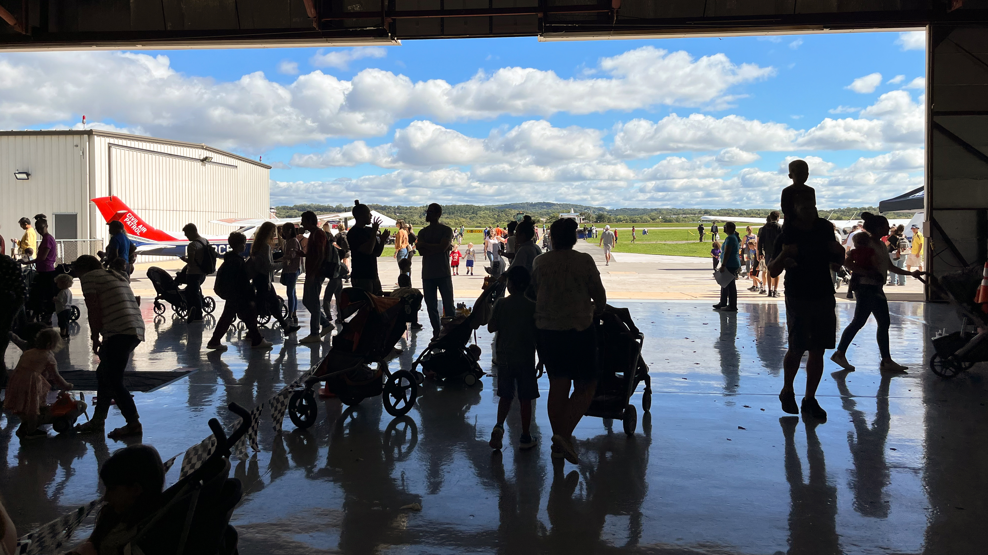 Strolling out of the National Aviation Community Center to watch all the other attractions on the field. Photo by Sylvia Horne.
