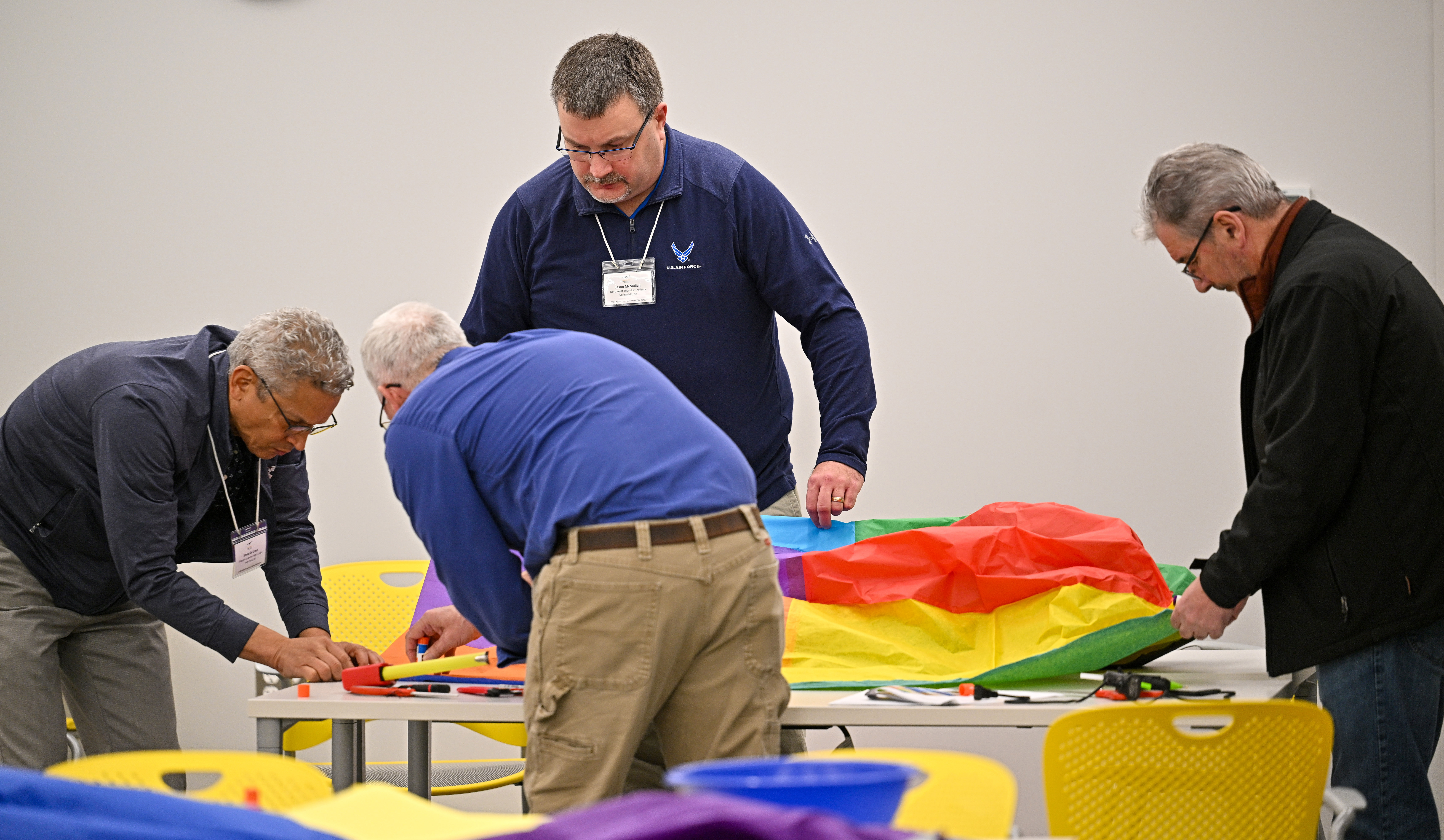 High school educators including Jonas De Leon, Jason McMullen, and Derek Rowe (left to right facing camera) participate in hands-on exercises at the AOPA campus to help teach science, technology, engineering, and math skills related to aviation on January 9. Photo by David Tulis.