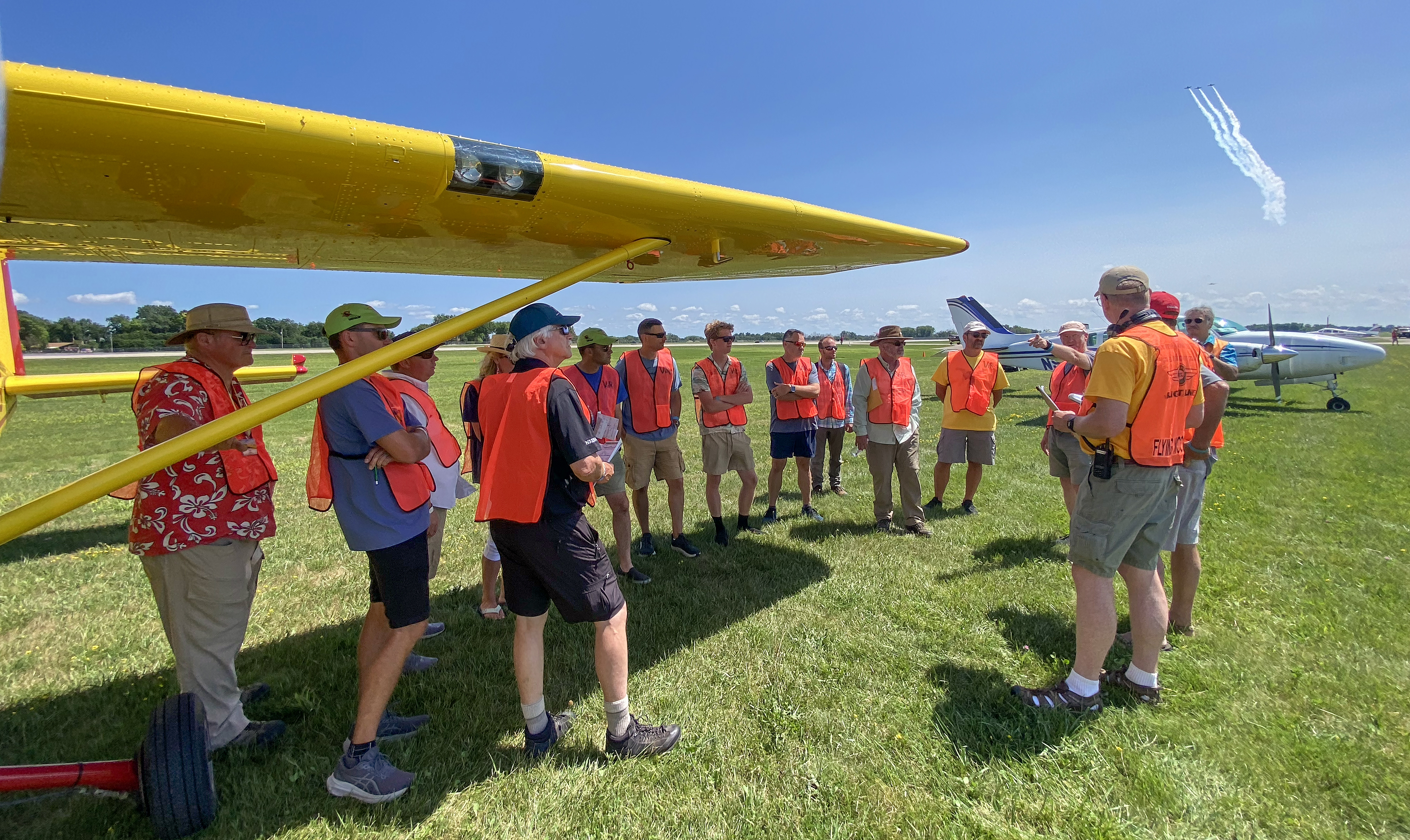 Vintage in Review flyover pilots attend a final briefing at the staging area before participating in the July 25 afternoon airshow. Photo courtesy of Jennifer Payne, EAA.