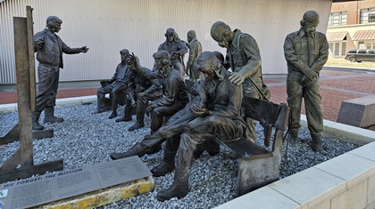 Bronze statutes outside the National WWII Museum depict a wartime mission briefing, evoking the stress that the crews were under and the sacrifices of so many. Photo by Chip Wright.