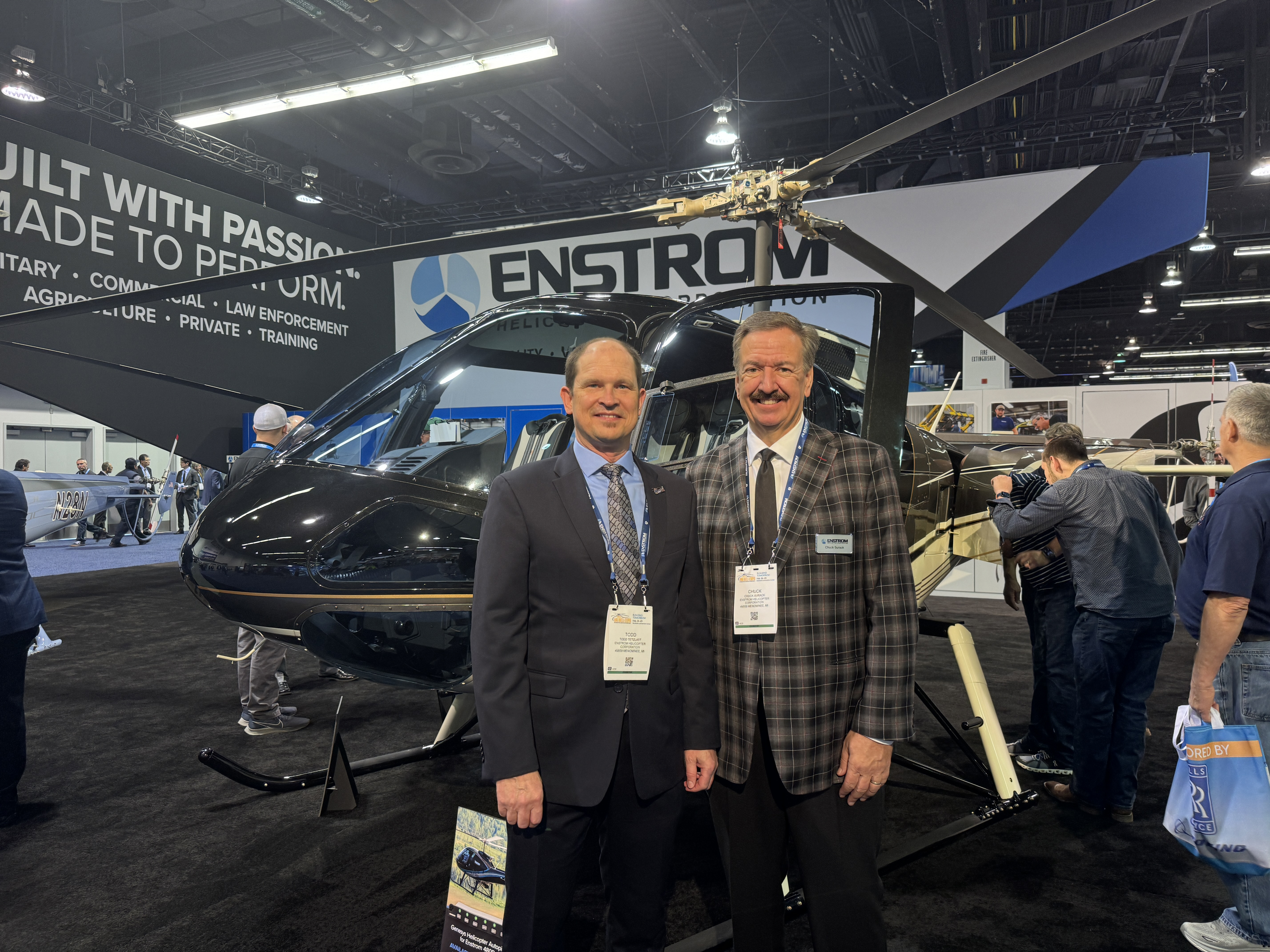 Enstrom owner Chuck Surack and President Todd Tetzlaff pose for a photo in front of the Enstrom 480B on display at HAI Heli-Expo 2024. Photo by Niki Britton.