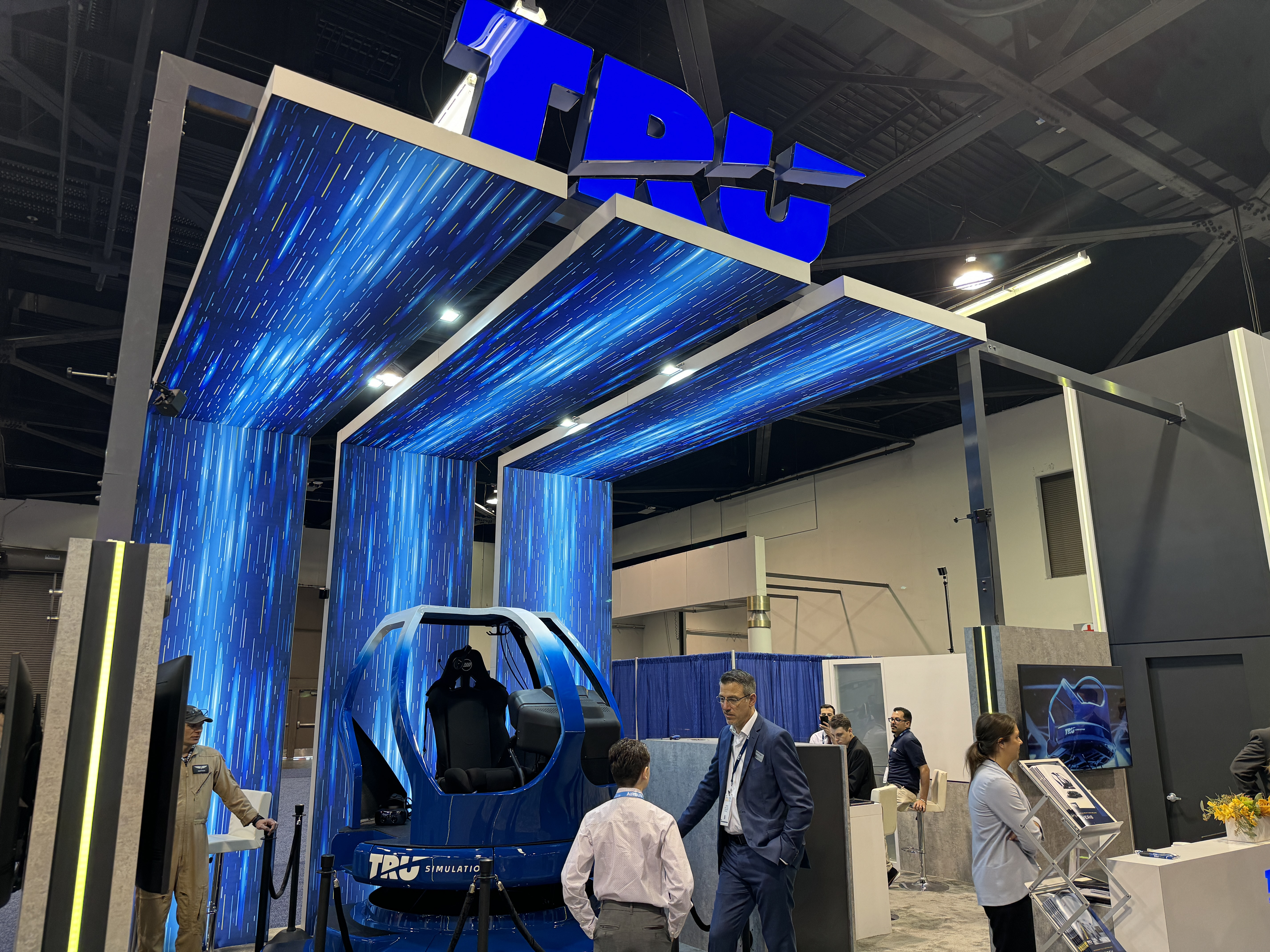 TRU Simulation staff members speak to interested visitors about the release of the company’s new virtual reality simulator on display at HAI Heli-Expo 2024. Photo by Niki Britton.