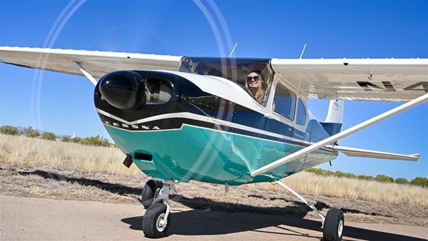 AOPA's Niki Britton is the project manager for the AOPA Sweepstakes Cessna 182 Skylane, which is painted in a retro-throwback paint scheme by Gus Haussler of Master Aircraft Services Inc., and his crew at Bisbee Douglas International Airport in Arizona with colors reminiscent of the Skylane that graced the very first cover of 'AOPA Pilot' magazine in March 1958. Photo by David Tulis.