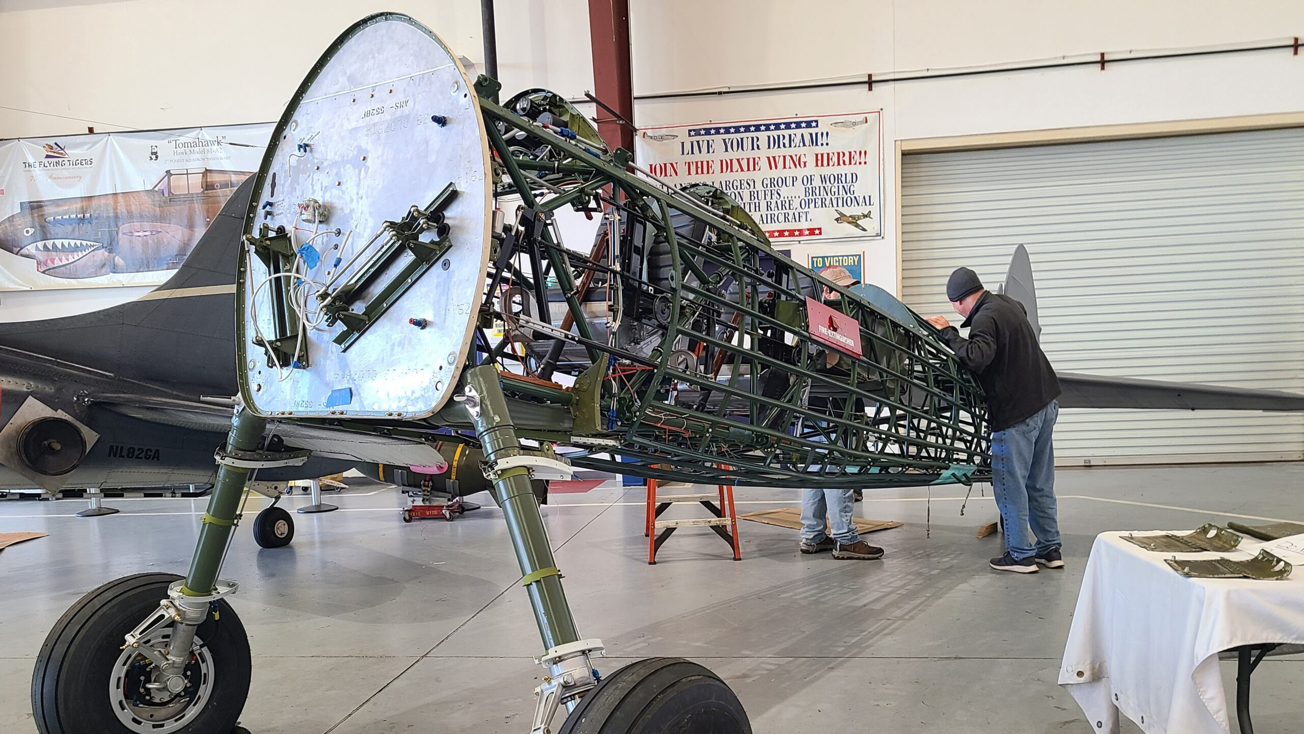 The World War II Stearman biplane trainer being restored at Commemorative Air Force Airbase Georgia in Peachtree City now has 'feet' and a tail, and has graduated from the shop to the hangar. The CAF 12 Planes of Christmas annual fundraising campaign brought in $15,185 to help purchase an avionics package. Photo by Angela Decker, courtesy of the Commemorative Air Force.