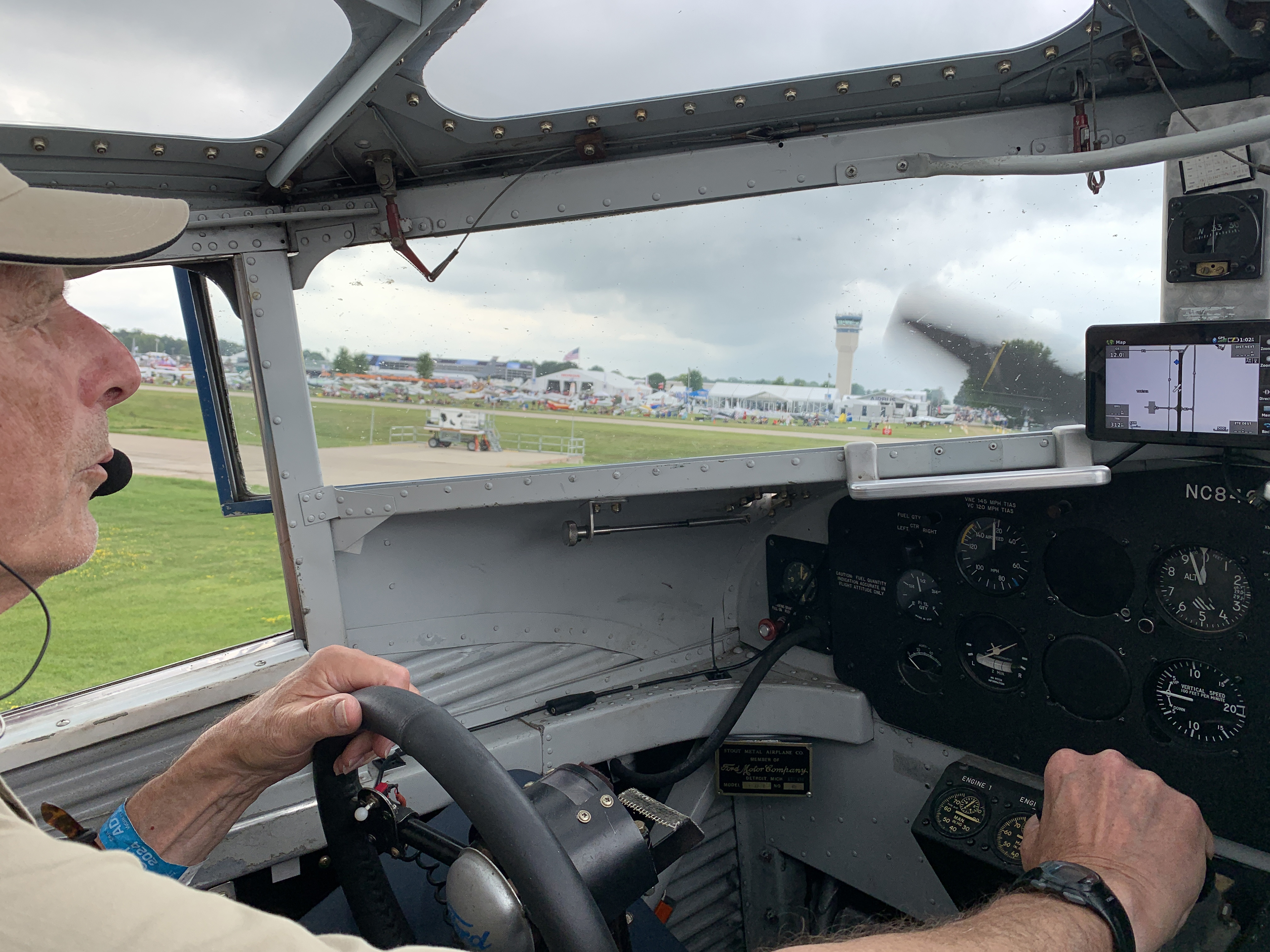 Pilot Ed Kornfield taxis the TriMotor down the flightline and past the tower at EAA AirVenture. Photo by Alicia Herron.