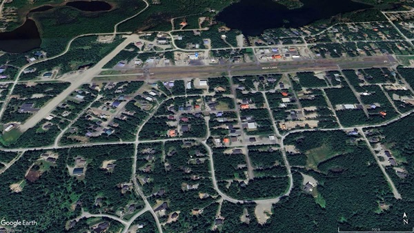 Michael Anthony Roberts pleaded guilty to flying a Piper Super Cub without a pilot certificate following a 2022 accident at Wolf Lake Airport in Alaska. Google Earth image.