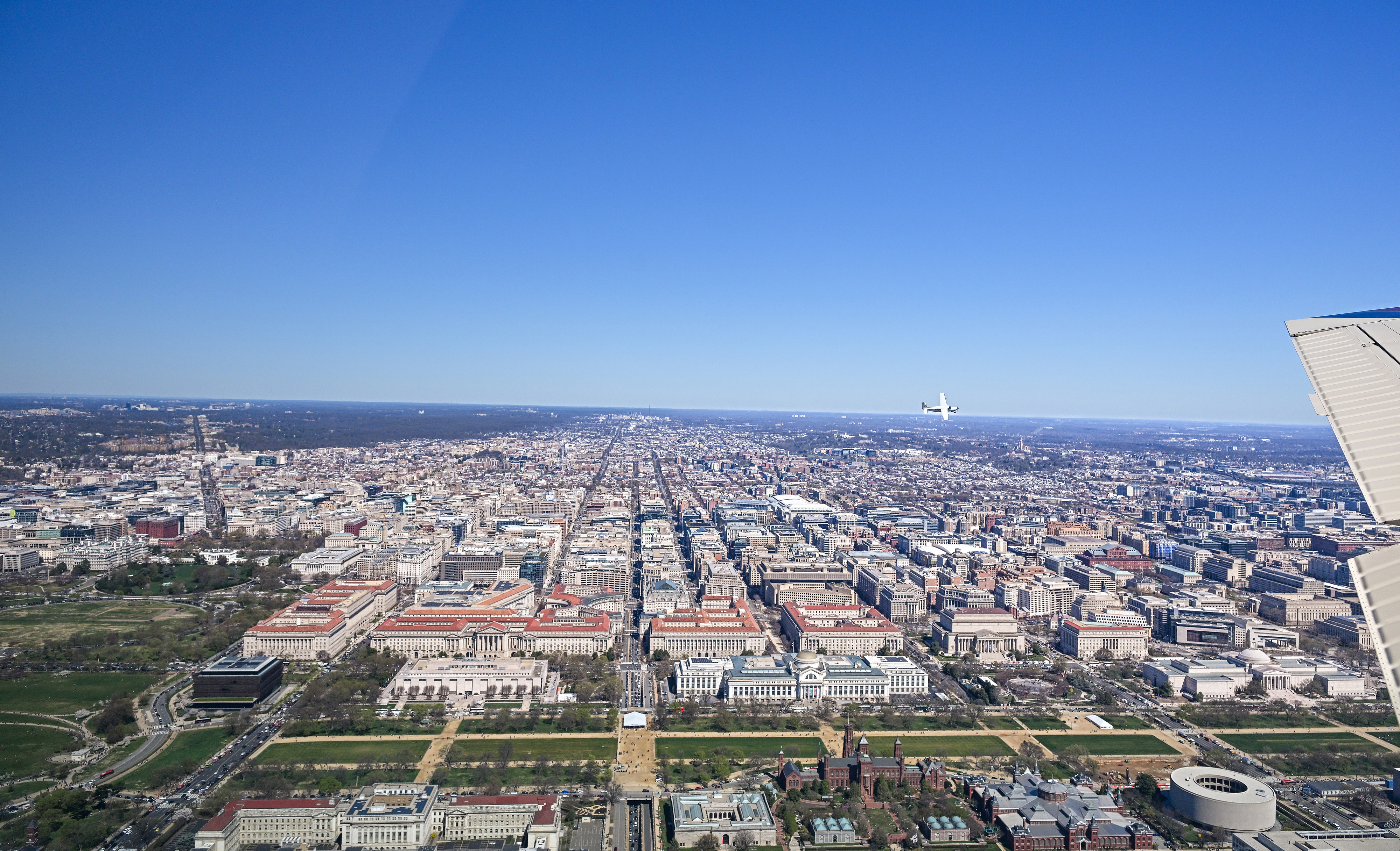 AOPA President Mark Baker, flying a Cessna 208 Caravan, turns right over the Smithsonian Institution Building known as the 'Castle.' Photo by David Tulis.