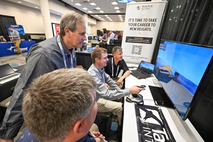 Michael Hangartner of Florida’s Rexair, a professional pilot academy, uses a computerized flight station demonstrated by Purdue University and TakeFlight Interactive. Photo by David Tulis.