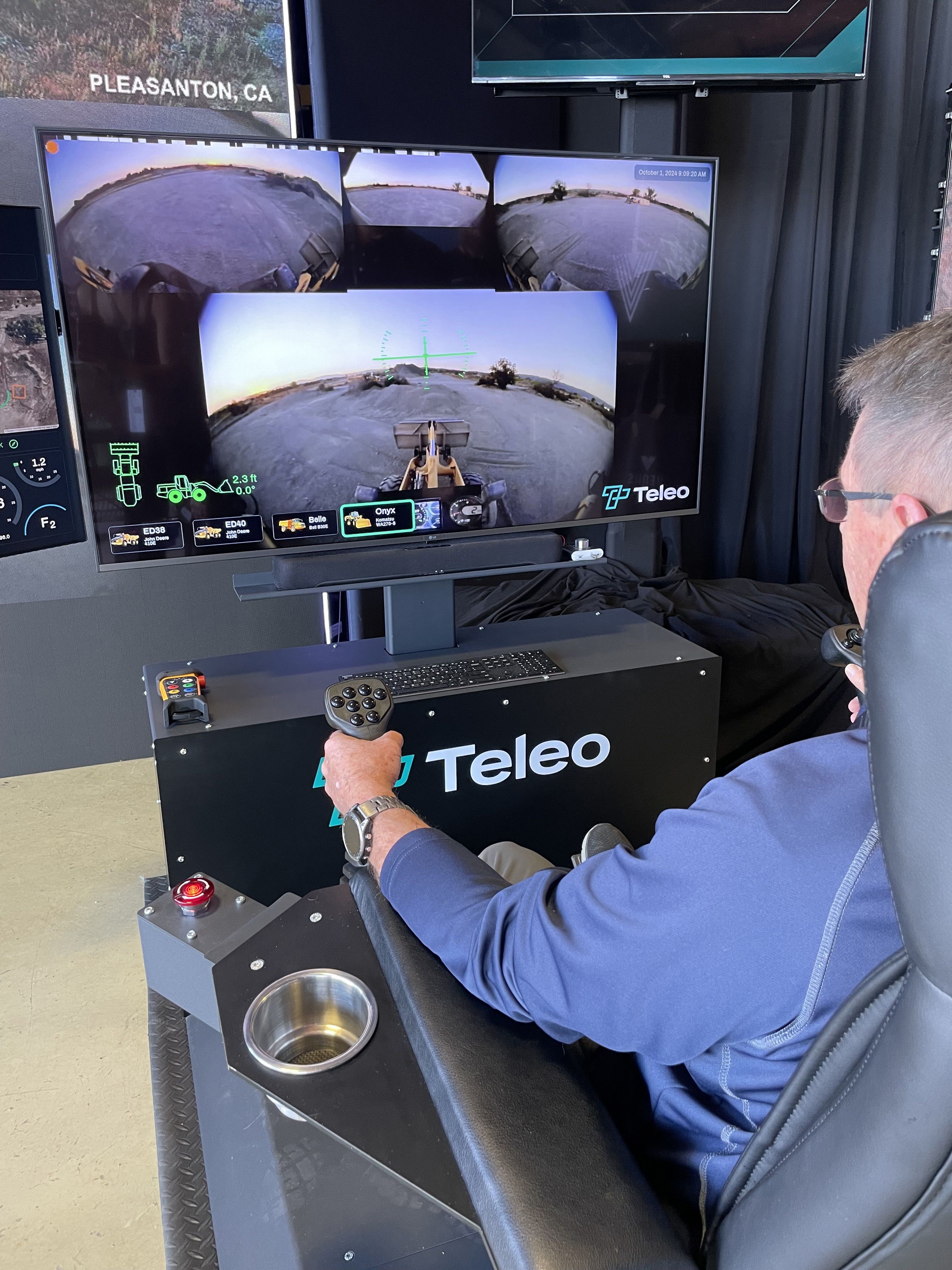 The author, a proficient pilot, but a rookie heavy equipment operator, drives a loader near Naples, Florida, from a control station in Bentonville, Arkansas. Teleo's "supervised autonomy" allows one remote operator to control and oversee as many as eight pieces of equipment. Photo courtesy of Tom Haines.