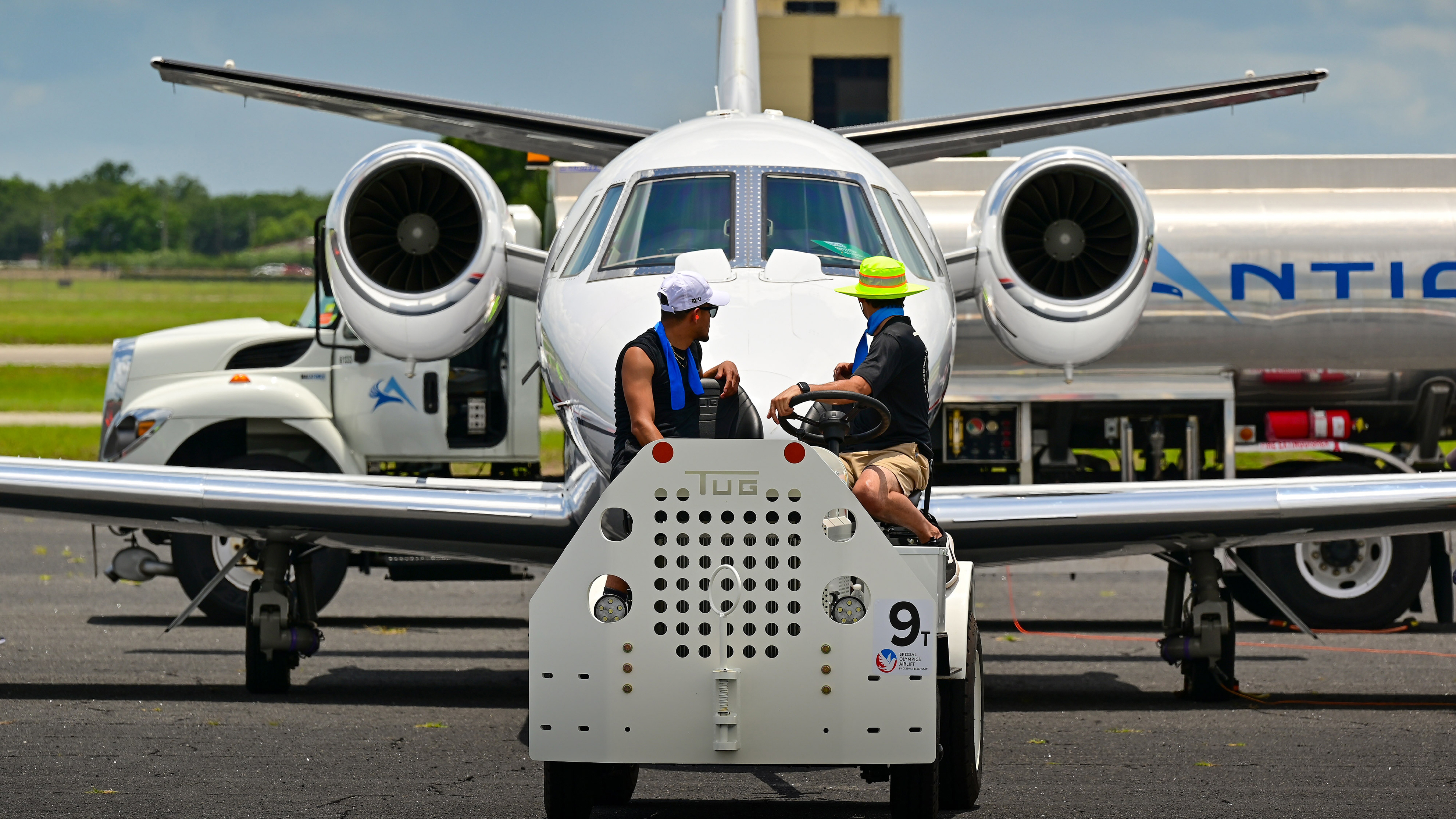 Line personnel at Orlando Executive Airport move a jet during the Textron Aviation-sponsored Citation Airlift transporting Special Olympics USA Games athletes and coaches to and from Orlando, Florida, in June 2022. Photo by David Tulis.