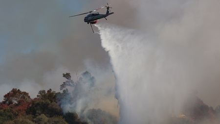 A Sikorsky UH-60 drops water on the Palisades Fire on January 9. Photo courtesy of Cal Fire.