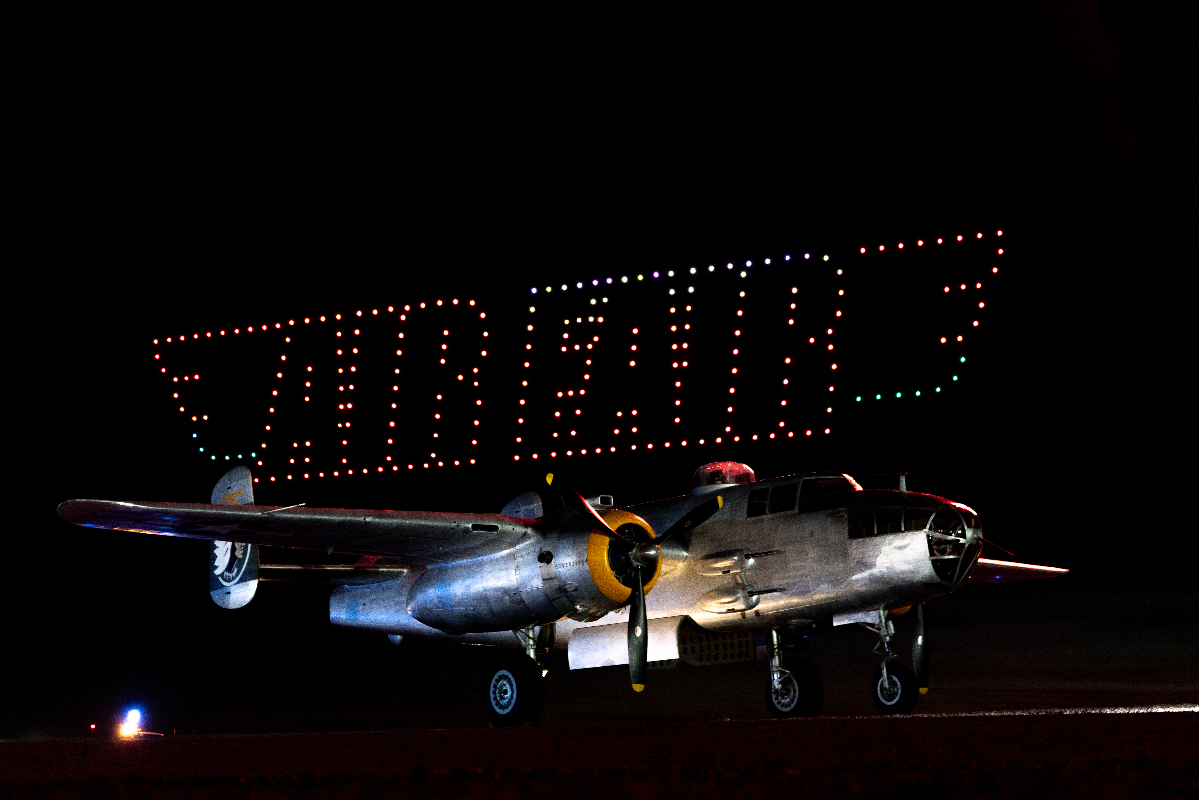Drones perform a colorful dance at the night airshow. Photo by Jake Teague.