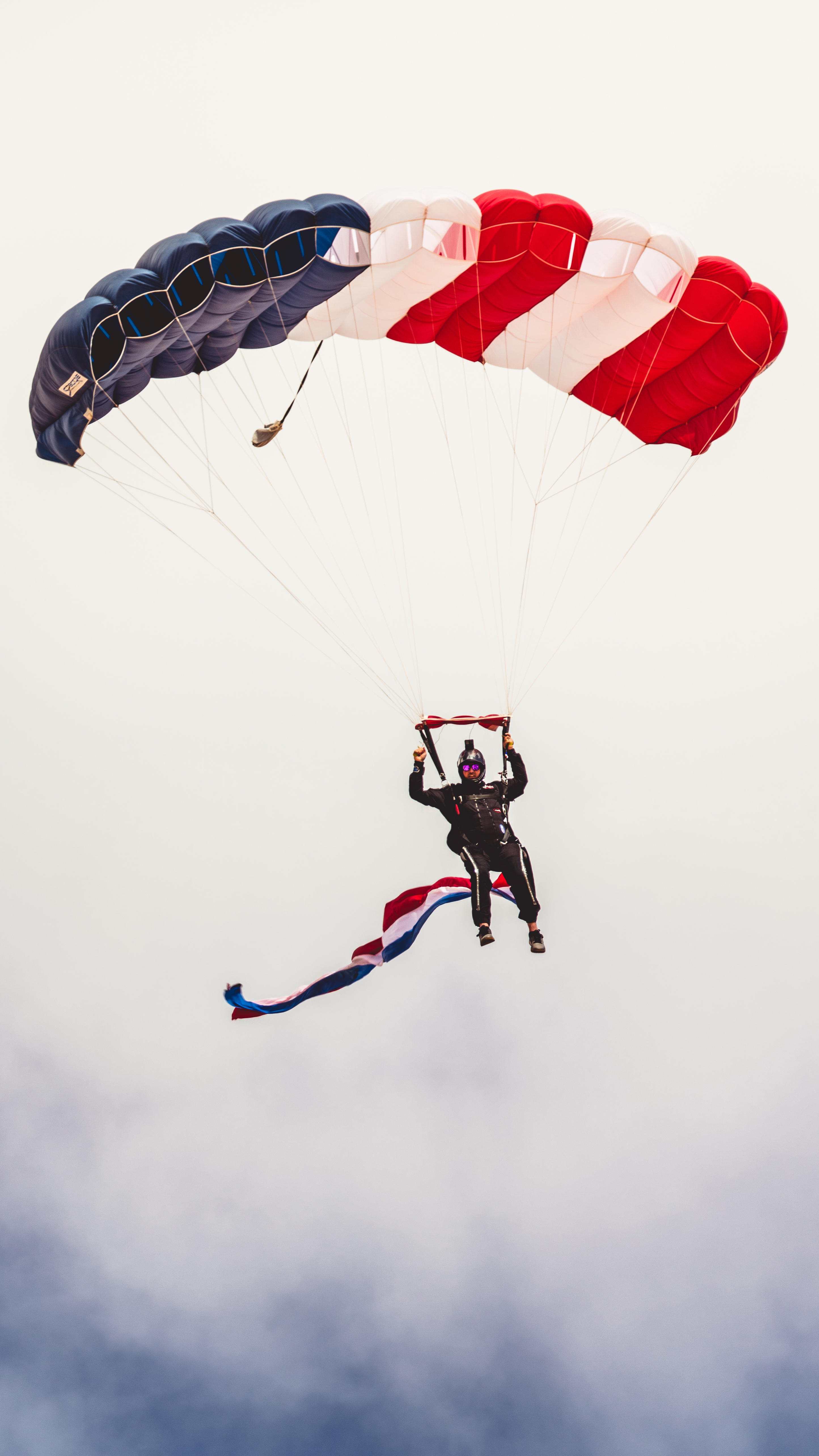 Skydivers from the Aerial Extreme Skydiving Team parachute onto the grounds of the Buckeye Air Fair. Photo by Jake Teague.