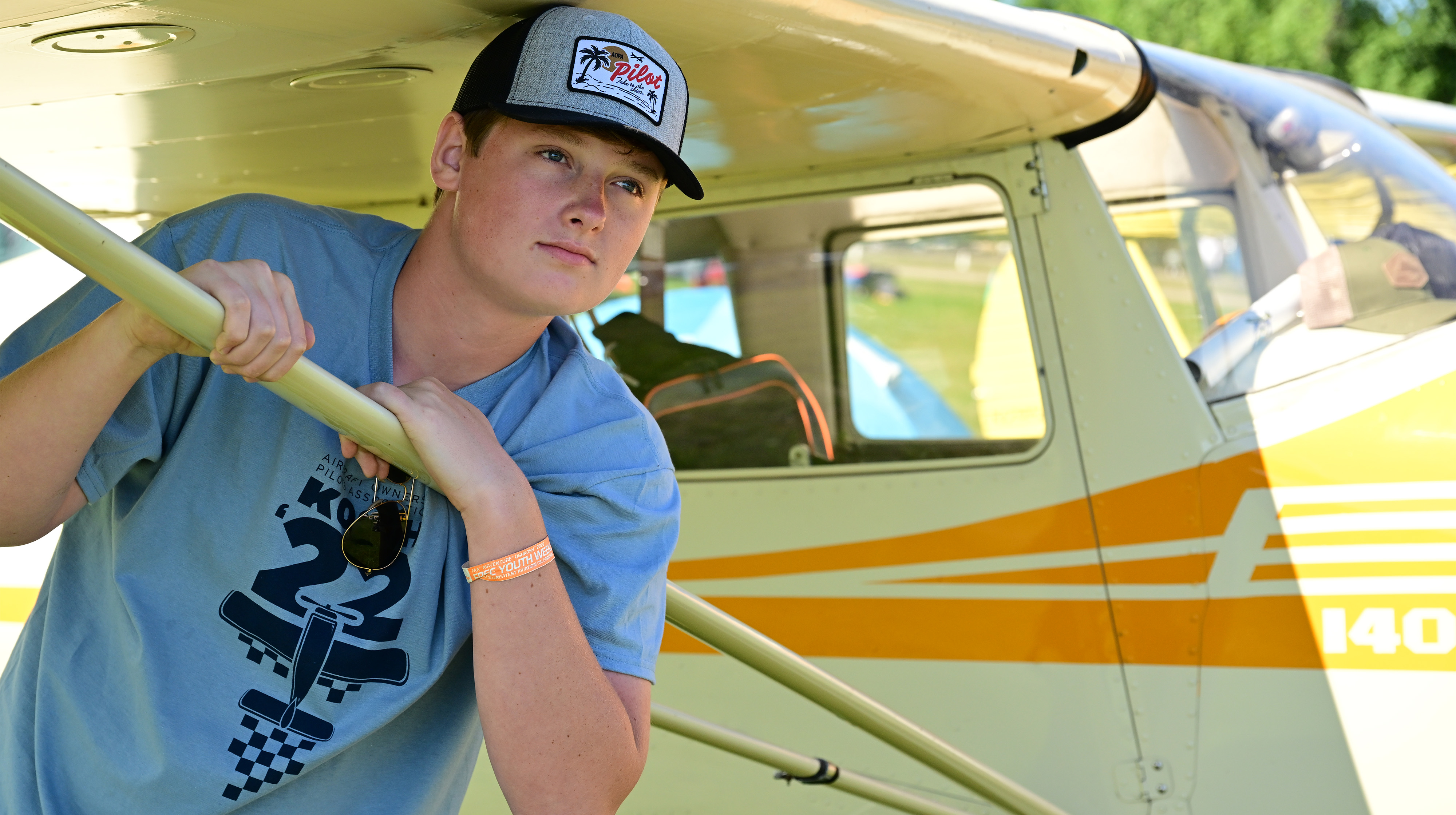 Private pilot and AOPA scholarship recipient Mason Rowe posed for a photo with the 1946 Cessna 140 that he flew solo at age 17 to EAA AirVenture Oshkosh 2022 in Wisconsin. Photo by David Tulis.