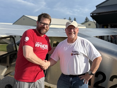 Sonex CEO and Highwing designer Mark Schaible, left, shakes the hand of test pilot and company advisor Joe Norris following the maiden flight. Photo courtesy of Sonex. 