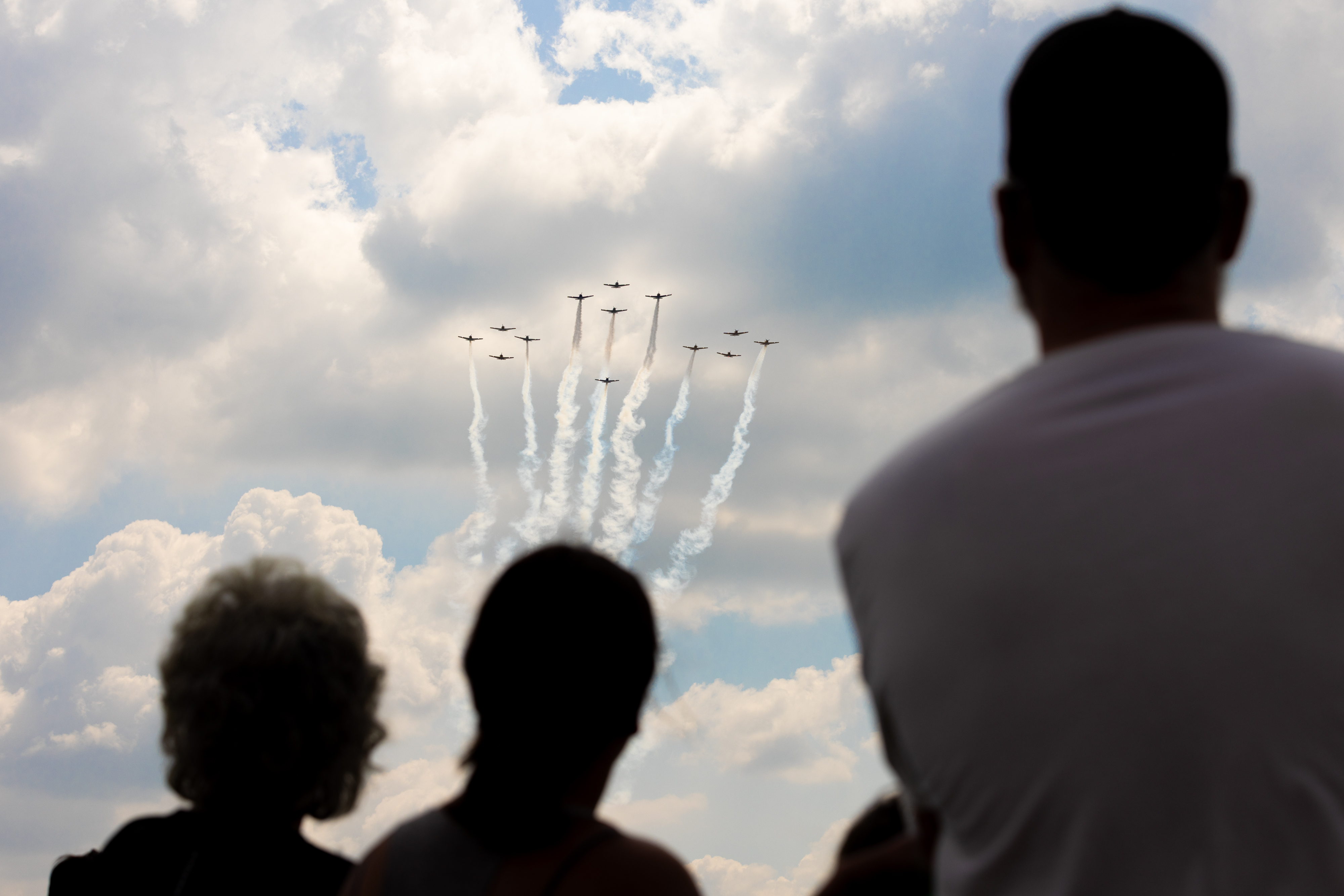 Crowds look upward as a formation of Beechcraft T-34 Mentors flies overhead. Photo by Rebecca Boone.