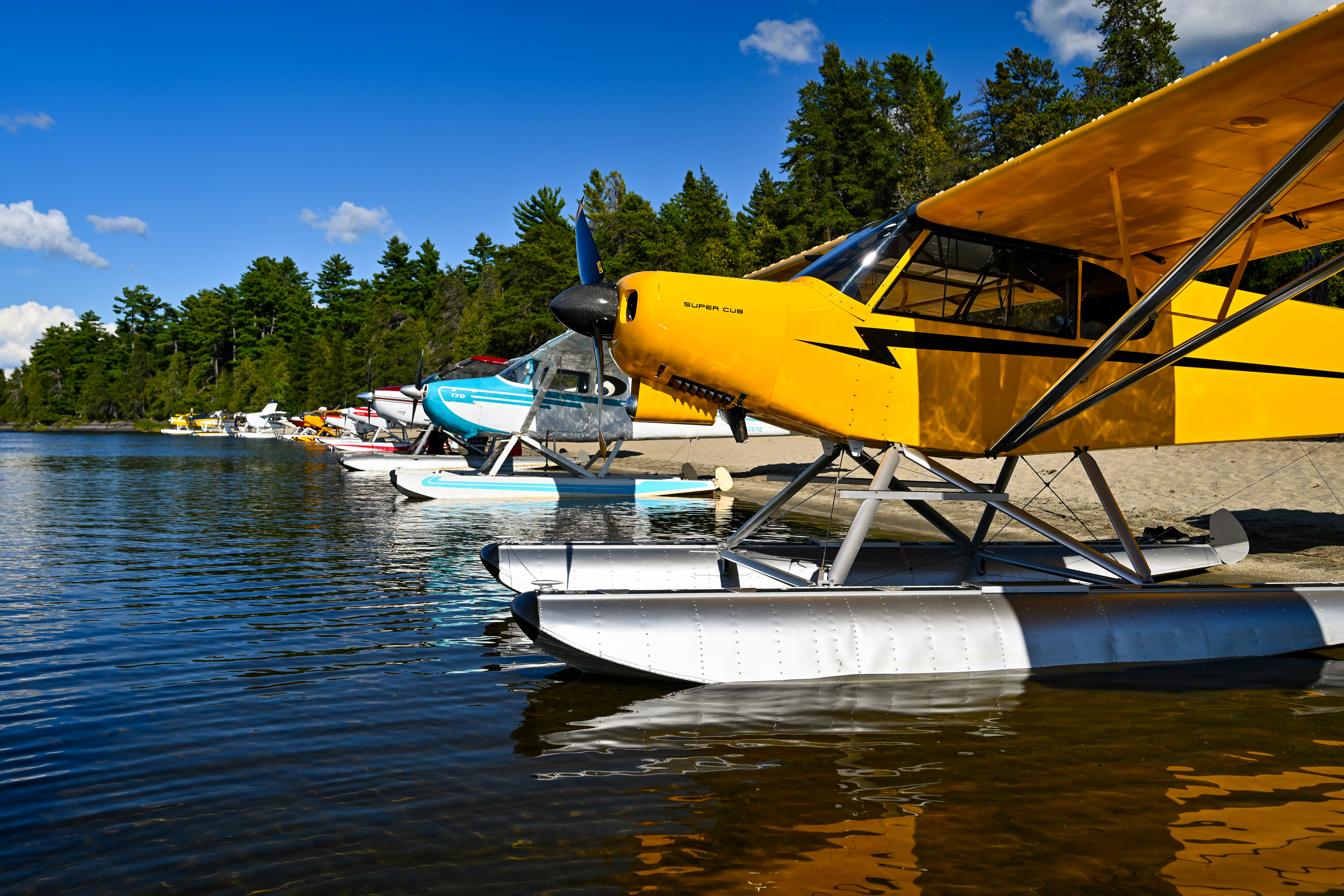 A Super Cub joins 36 seaplane pilots and their guests for an annual fly-out and cookout at Lobster Lake. Photo by David Tulis.