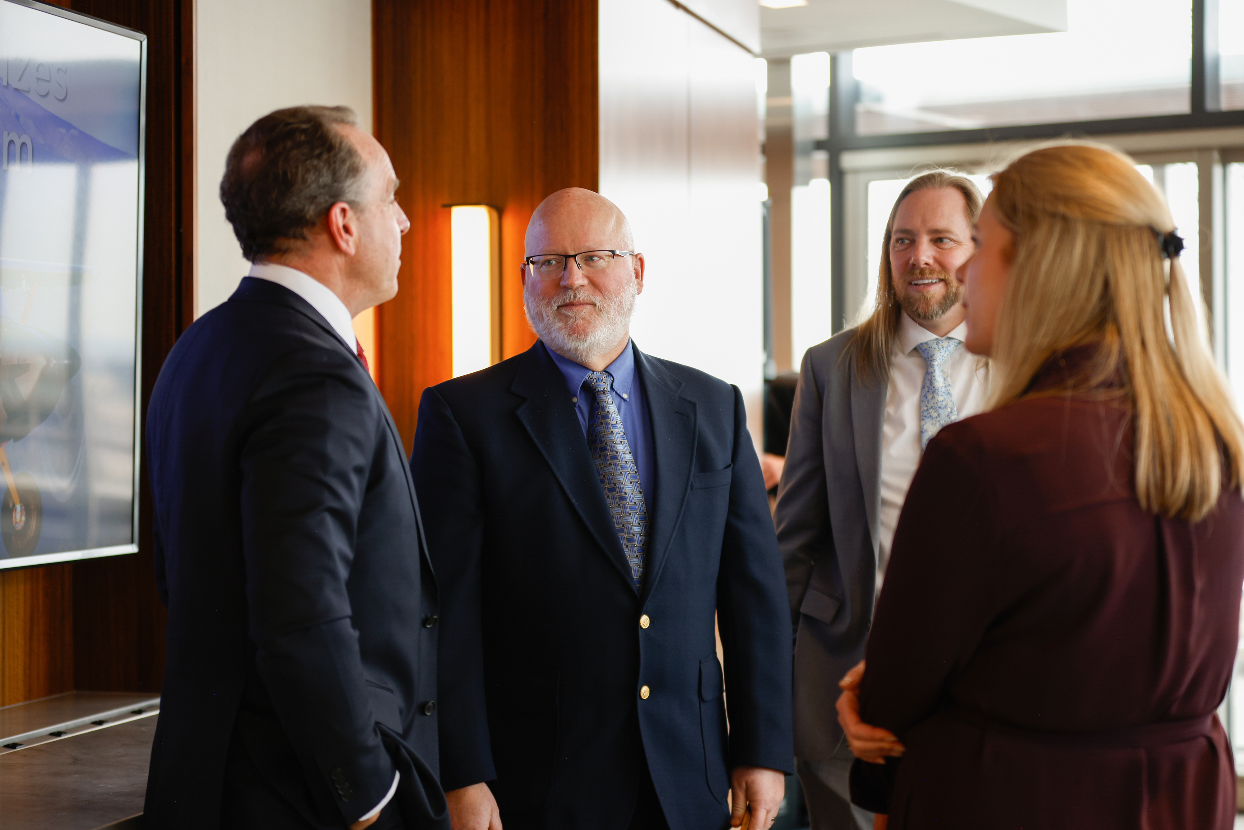 AOPA President Darren Pleasance, left, speaks with Jim Newberger and other award recipients after the ceremony. Photo by Rebecca Boone.