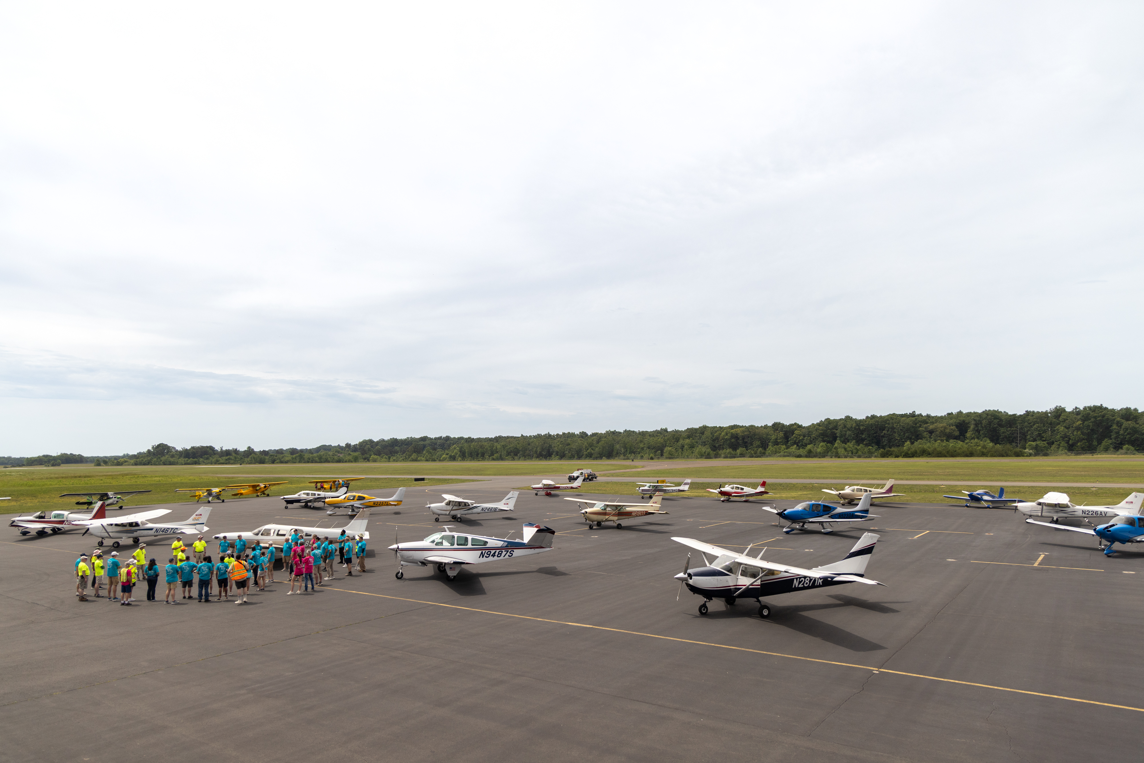 Pilots and volunteers gather to prepare for attendees’ first flights. Photo by Rebecca Boone.