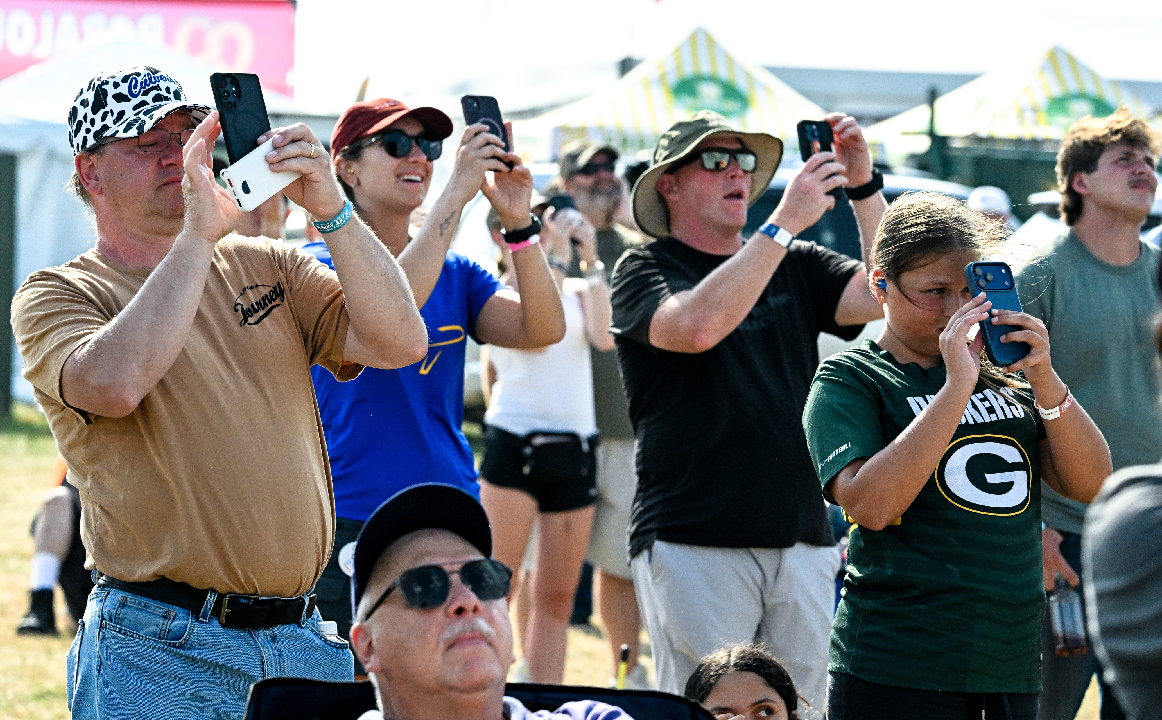 Airshow attendees document U.S. Air Force Lockheed Martin F-22 Raptor demo pilot Nick "Laz" Le Tourneau’s performance. Photo by David Tulis.