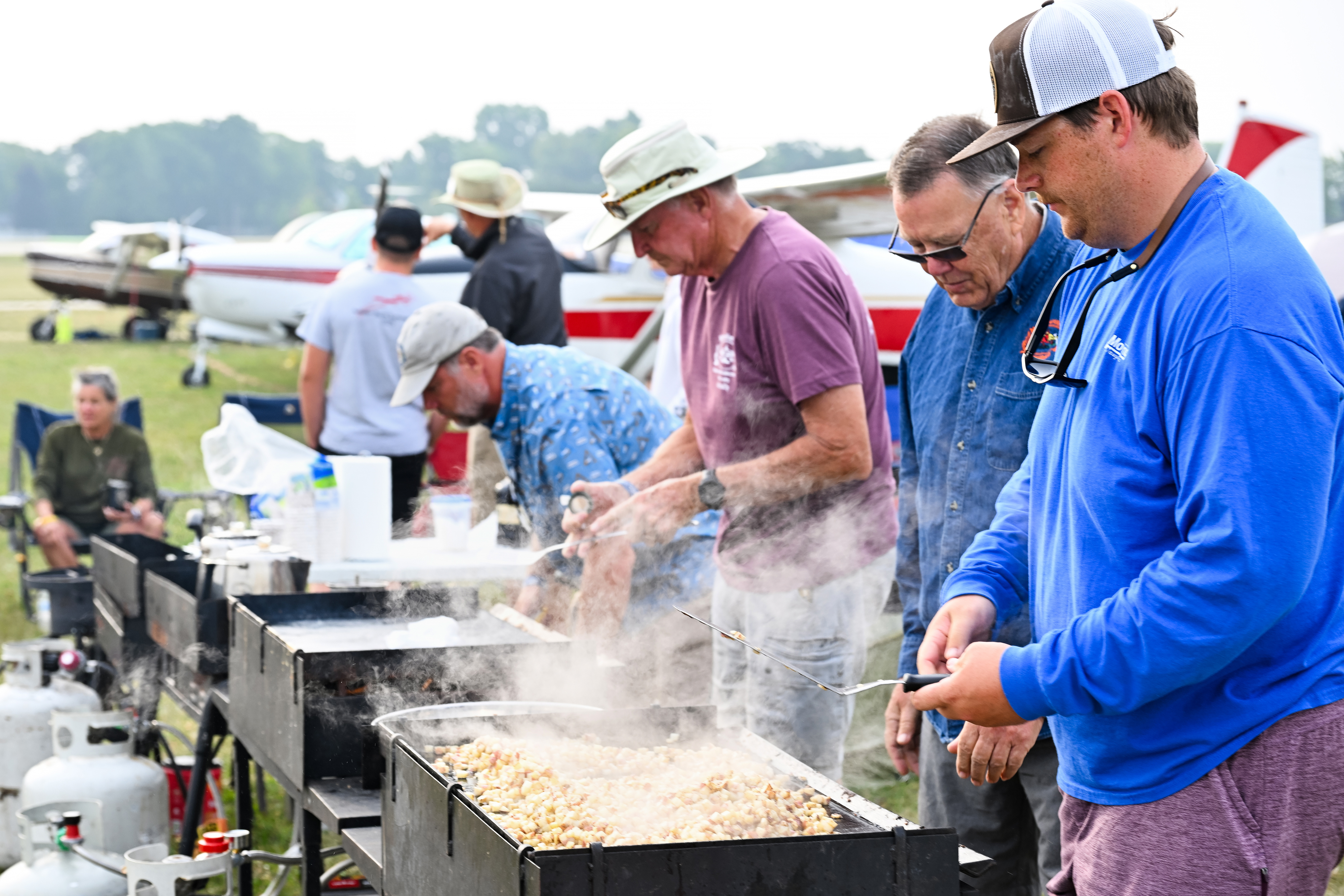 A group of pilots from the Metro Warbirds make breakfast on the flight line. Photo by David Tulis.