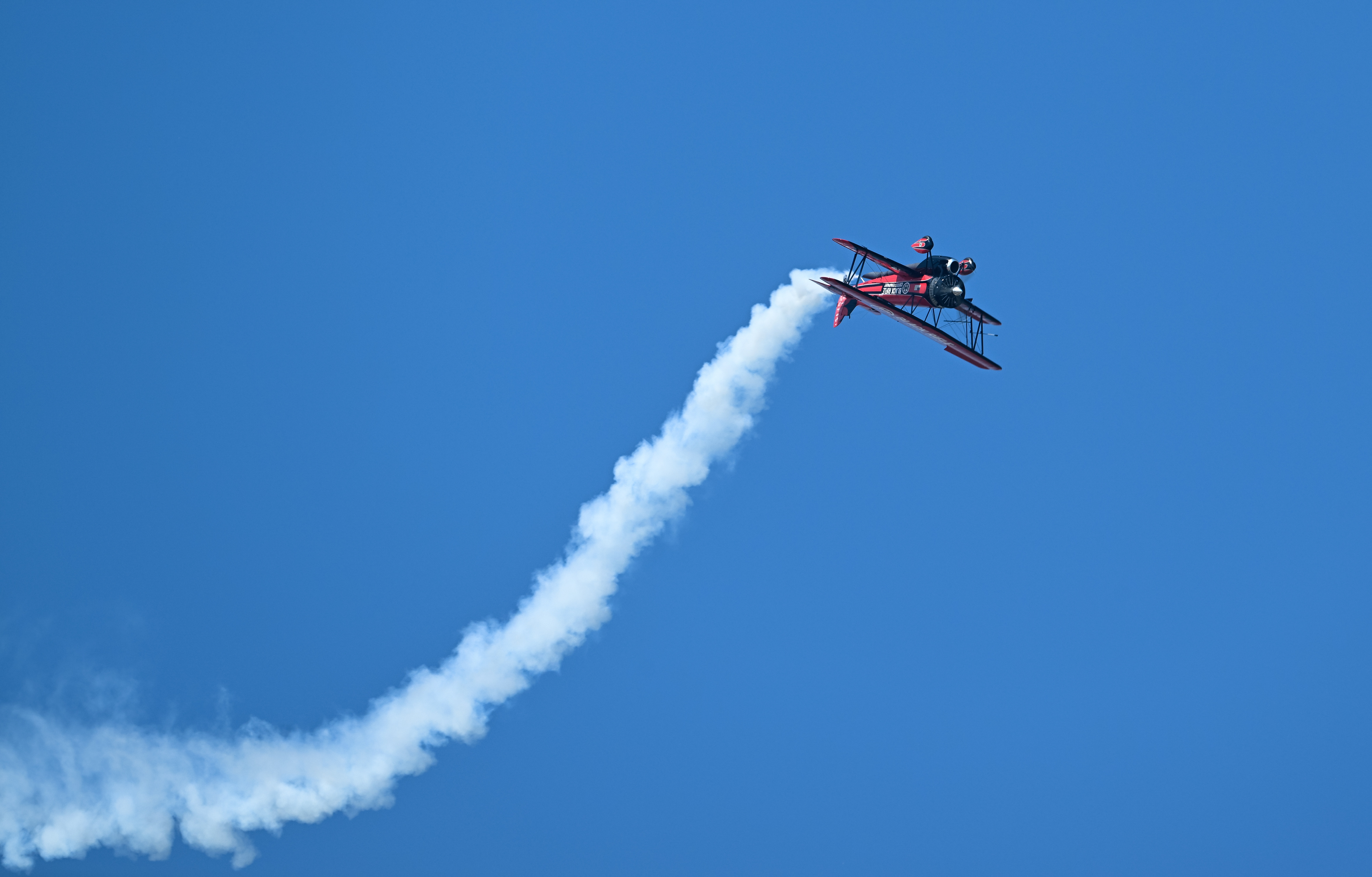 Jarrod Lindemann performs an inverted maneuver in a Jet Waco during the opening day airshow. Photo by David Tulis.