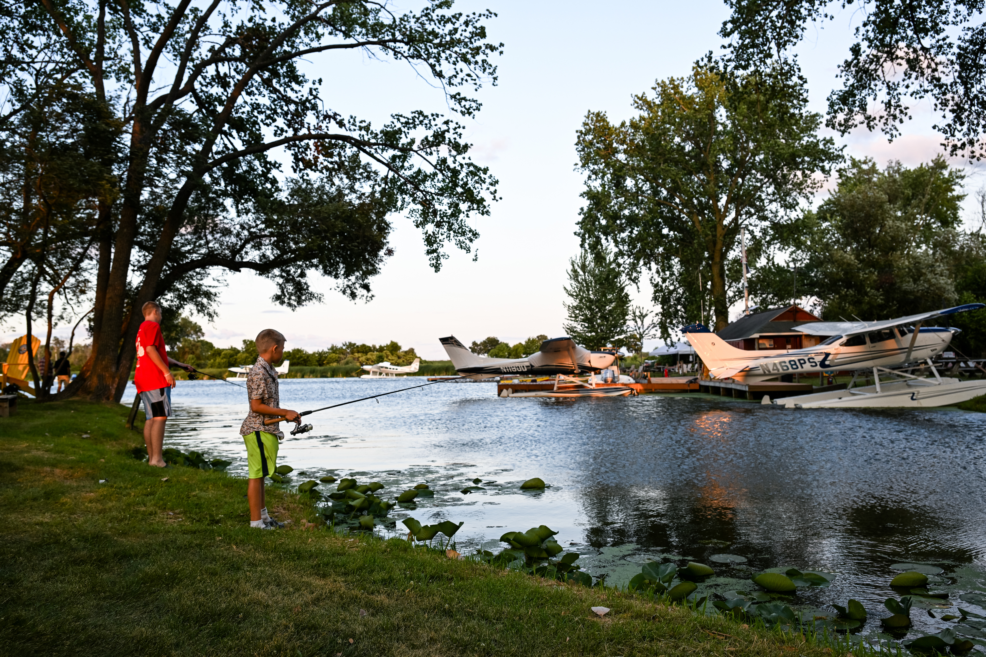 Airshow attendees enjoy a quiet moment fishing at the seaplane base. Photo by David Tulis.