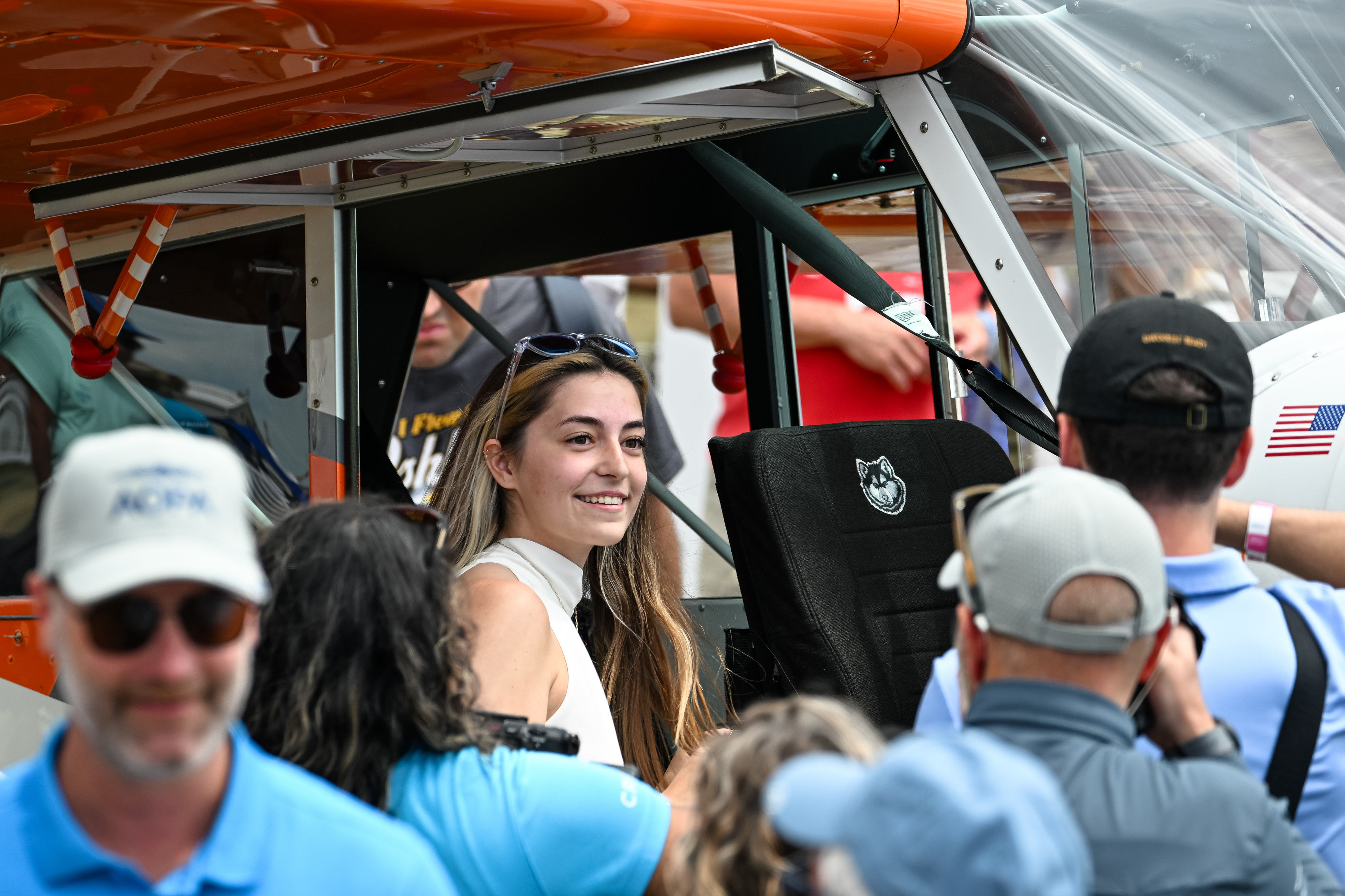 Pilot, flight instructor, and AOPA Sweepstakes Aviat Husky winner Ashley Almquist smiles before she climbs into her new aircraft. Photo by David Tulis.