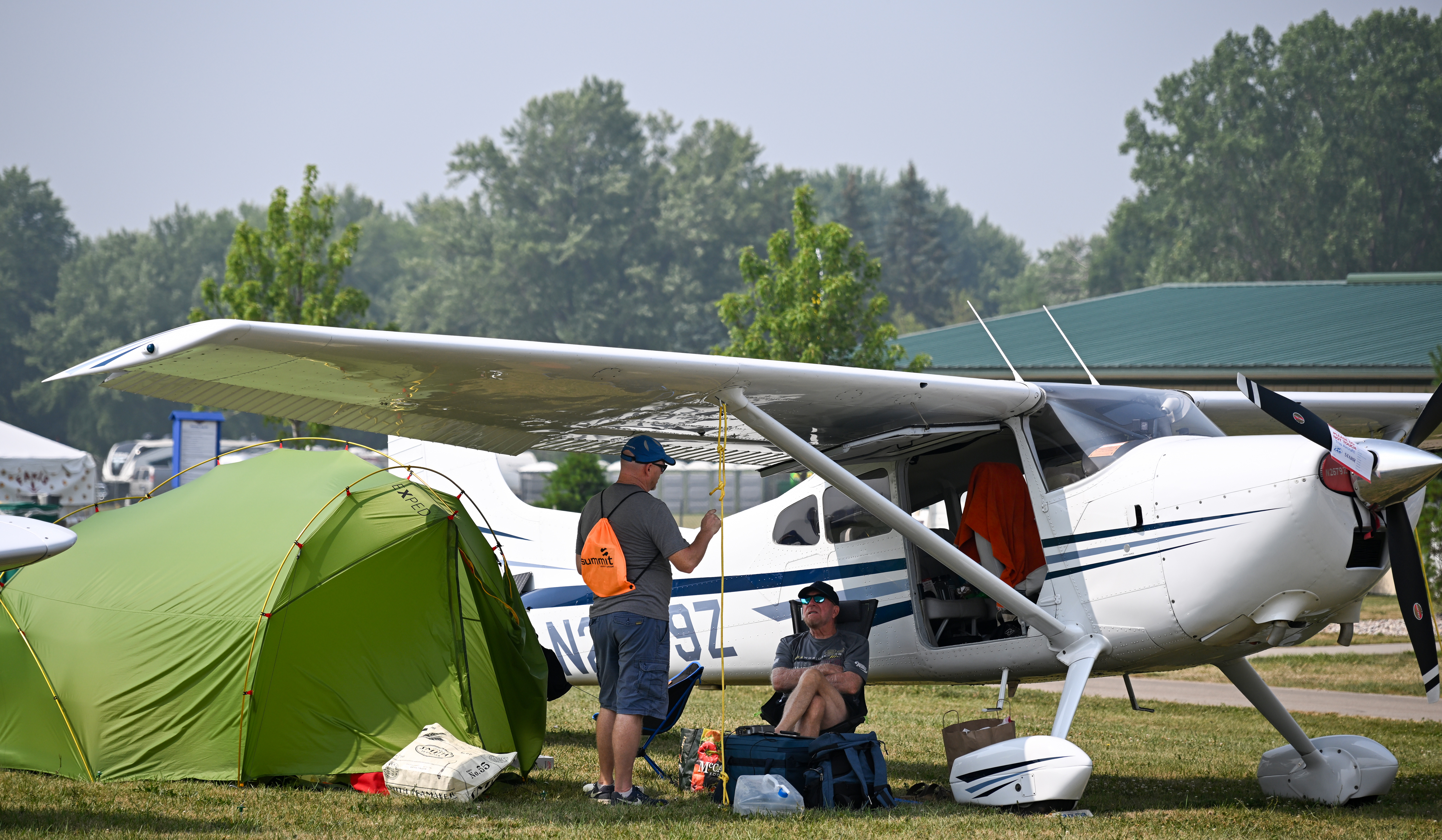 Campers relax under a Cessna. Photo by David Tulis.