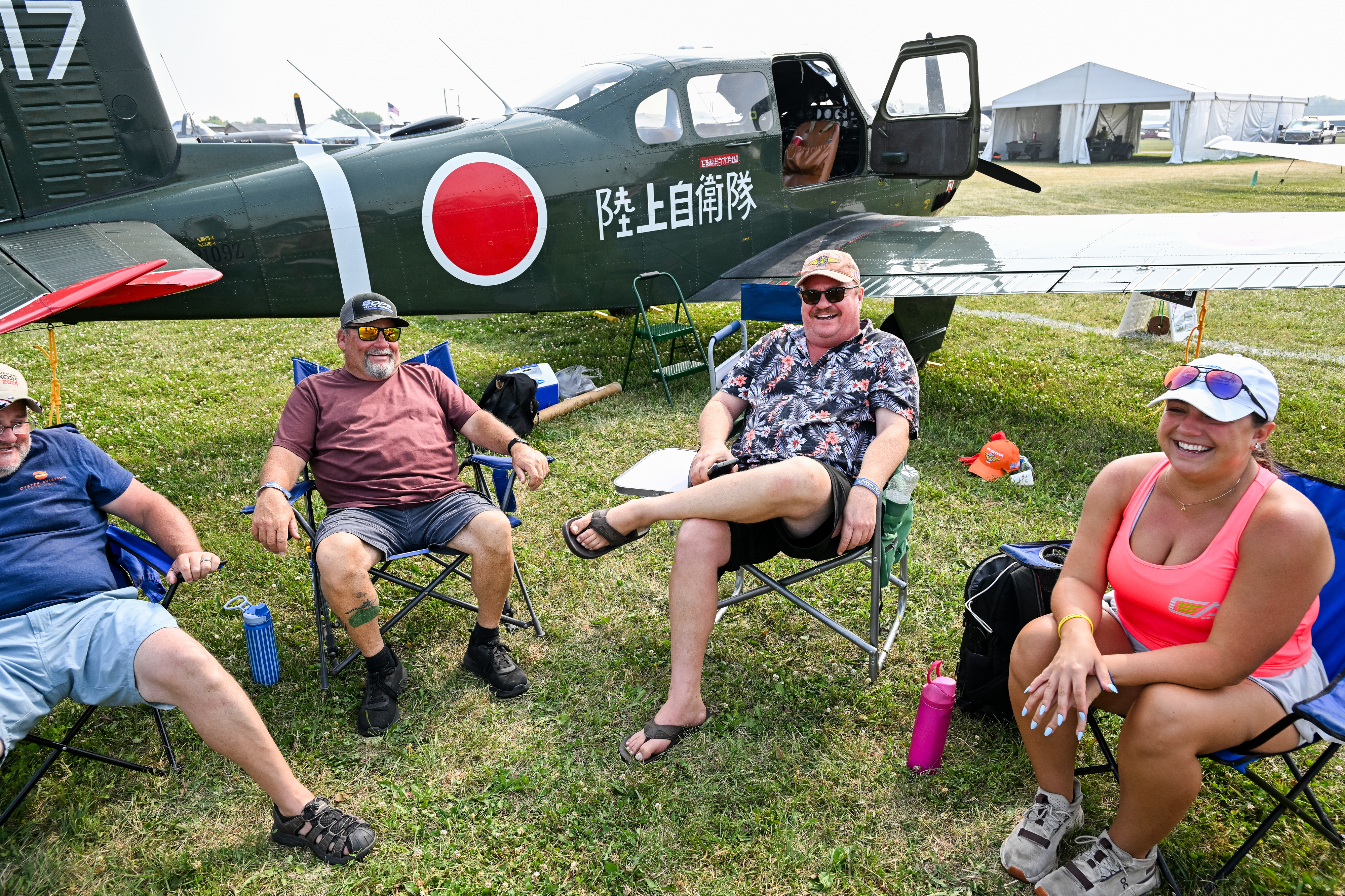 A group of Fuji pilots from Apalachicola, Florida, relax in the warbirds area after making the trip north. Photo by David Tulis.