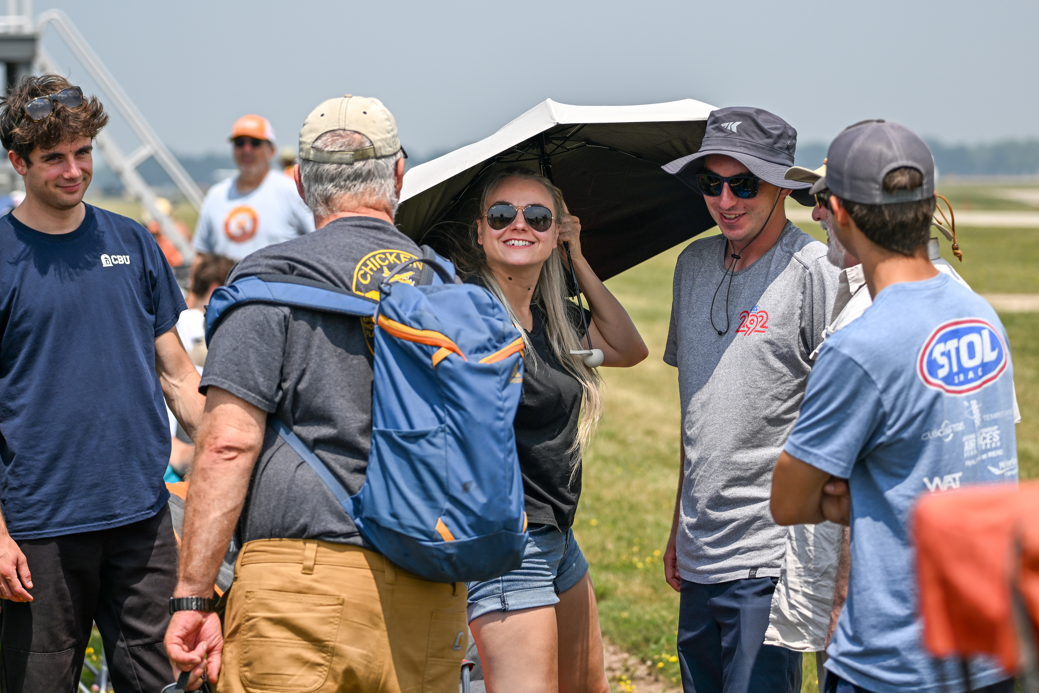 Airshow attendees greet one another on the flight line. Photo by David Tulis.