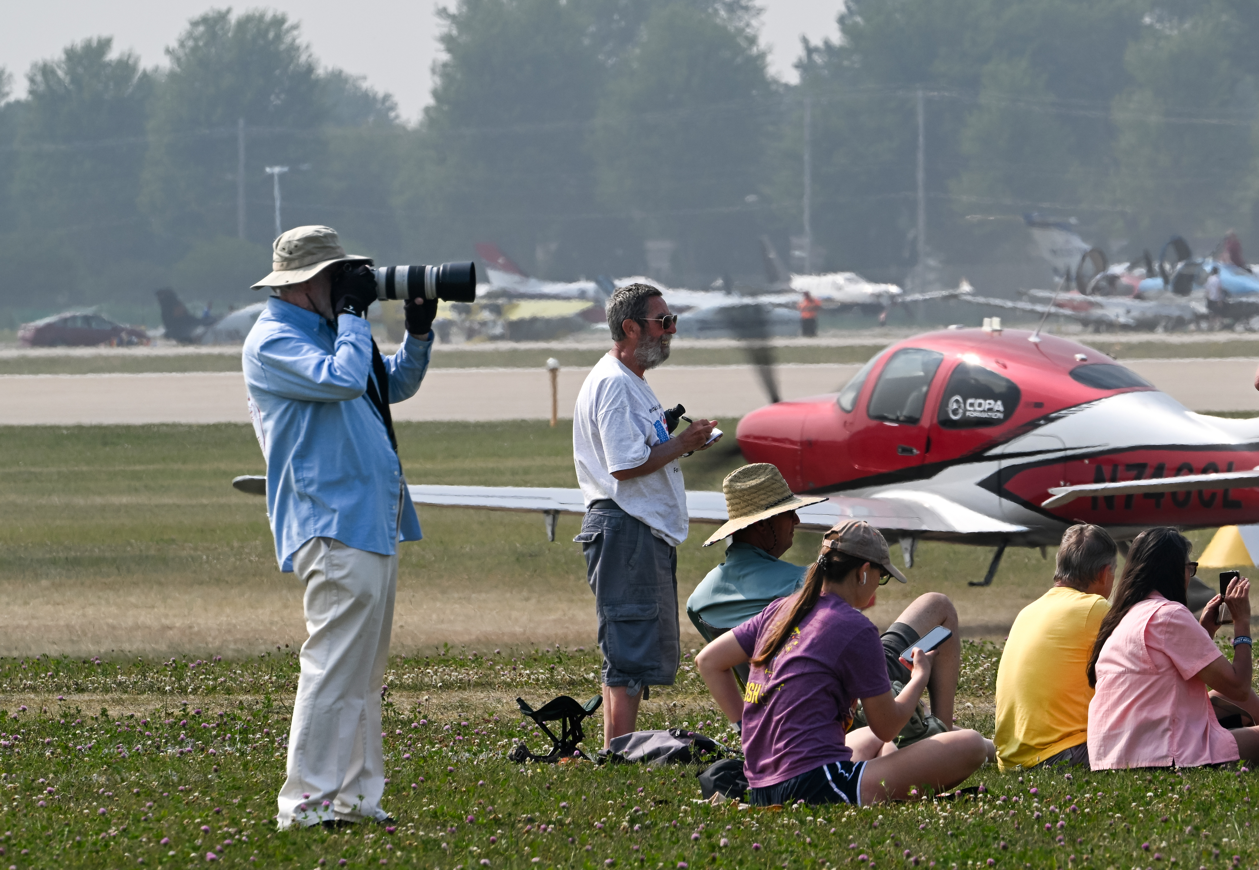 Attendees document the Cirrus Aircraft mass arrival. Photo by David Tulis.