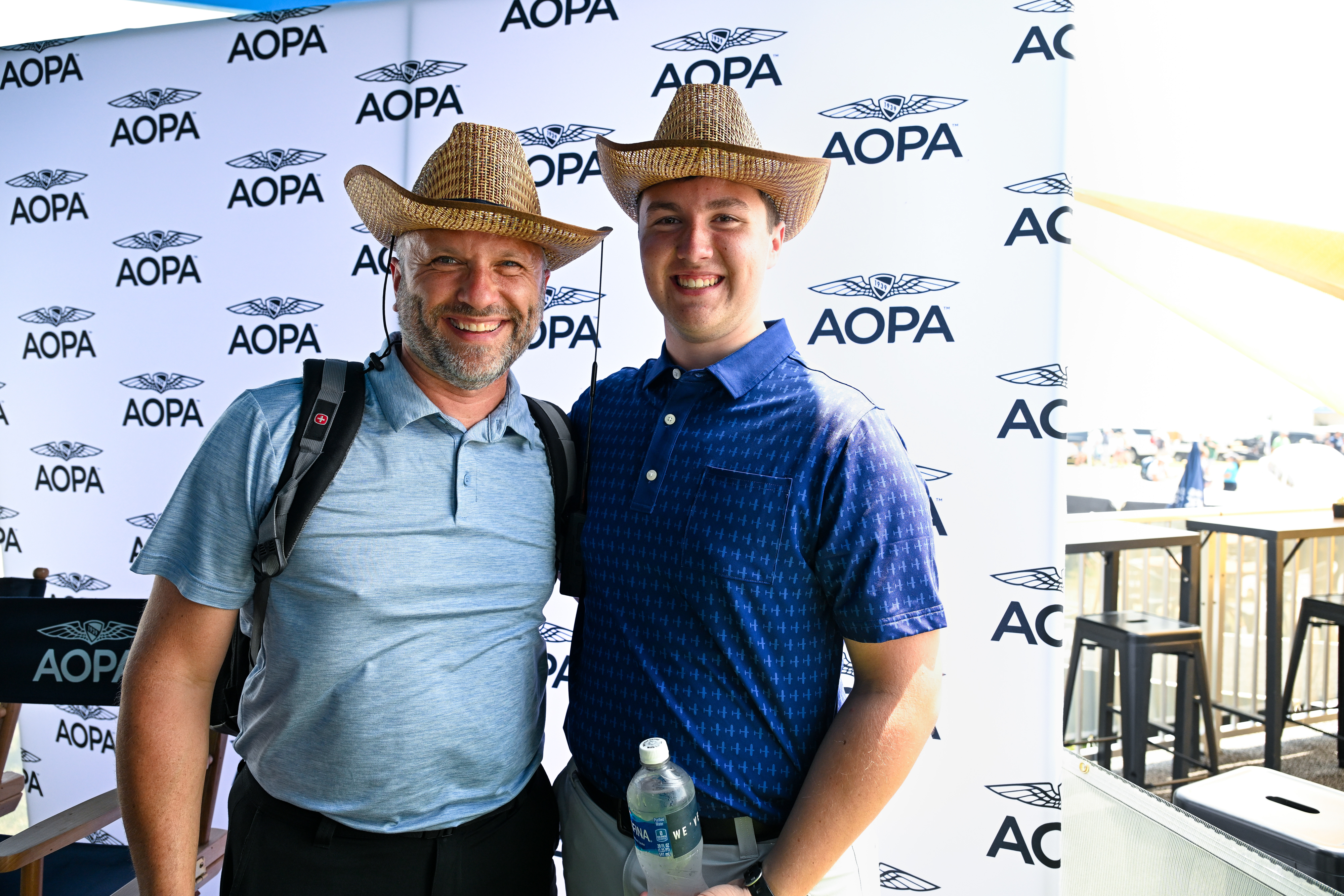 Attendees Duane and Patrick Pearson sport their AOPA straw hats. Photo by David Tulis.