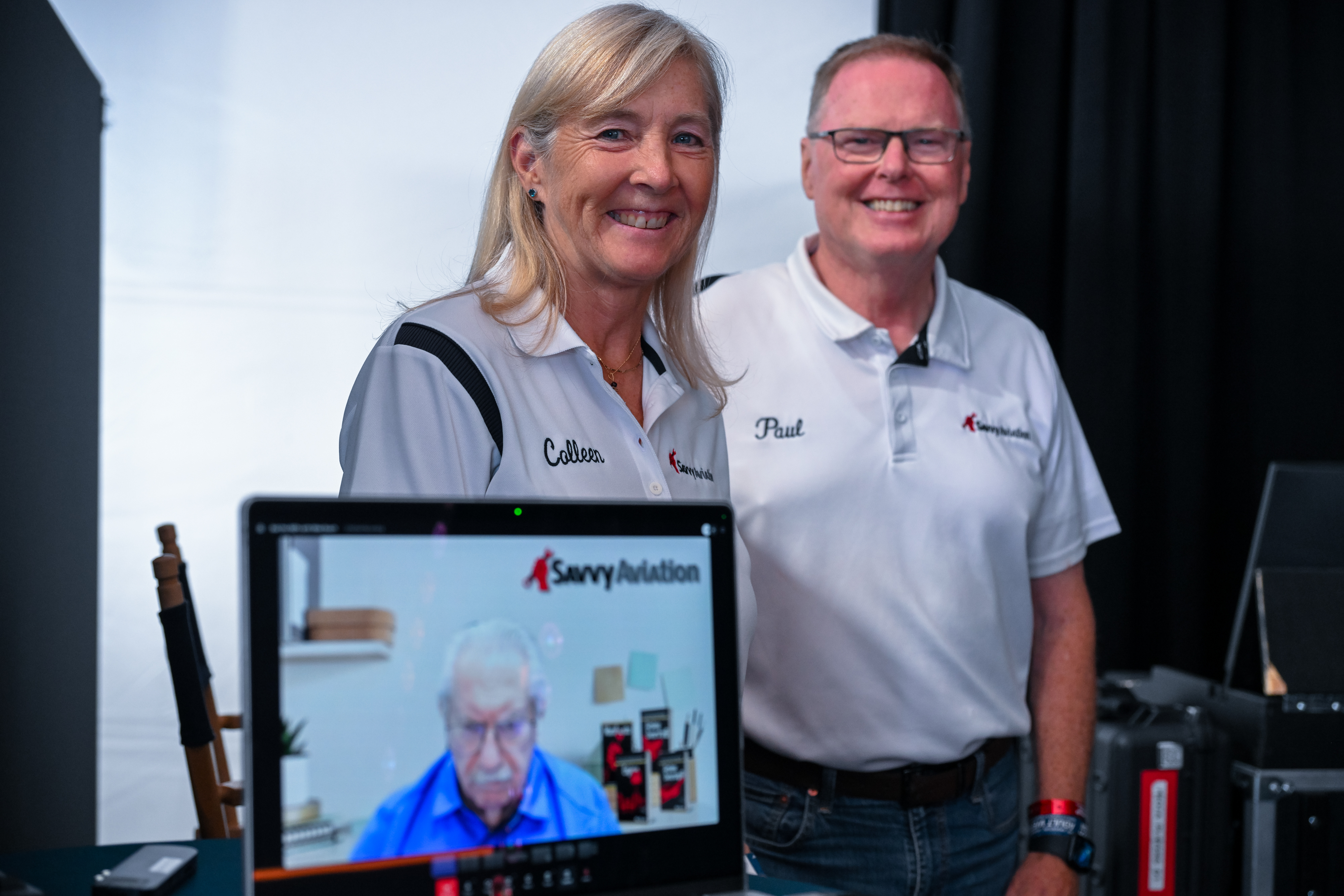 'Ask the A&Ps' podcast co-hosts Colleen Sterling, Paul New, and Mike Busch (via video) prepare to take the stage at the AOPA program pavilion tent. Photo by David Tulis.