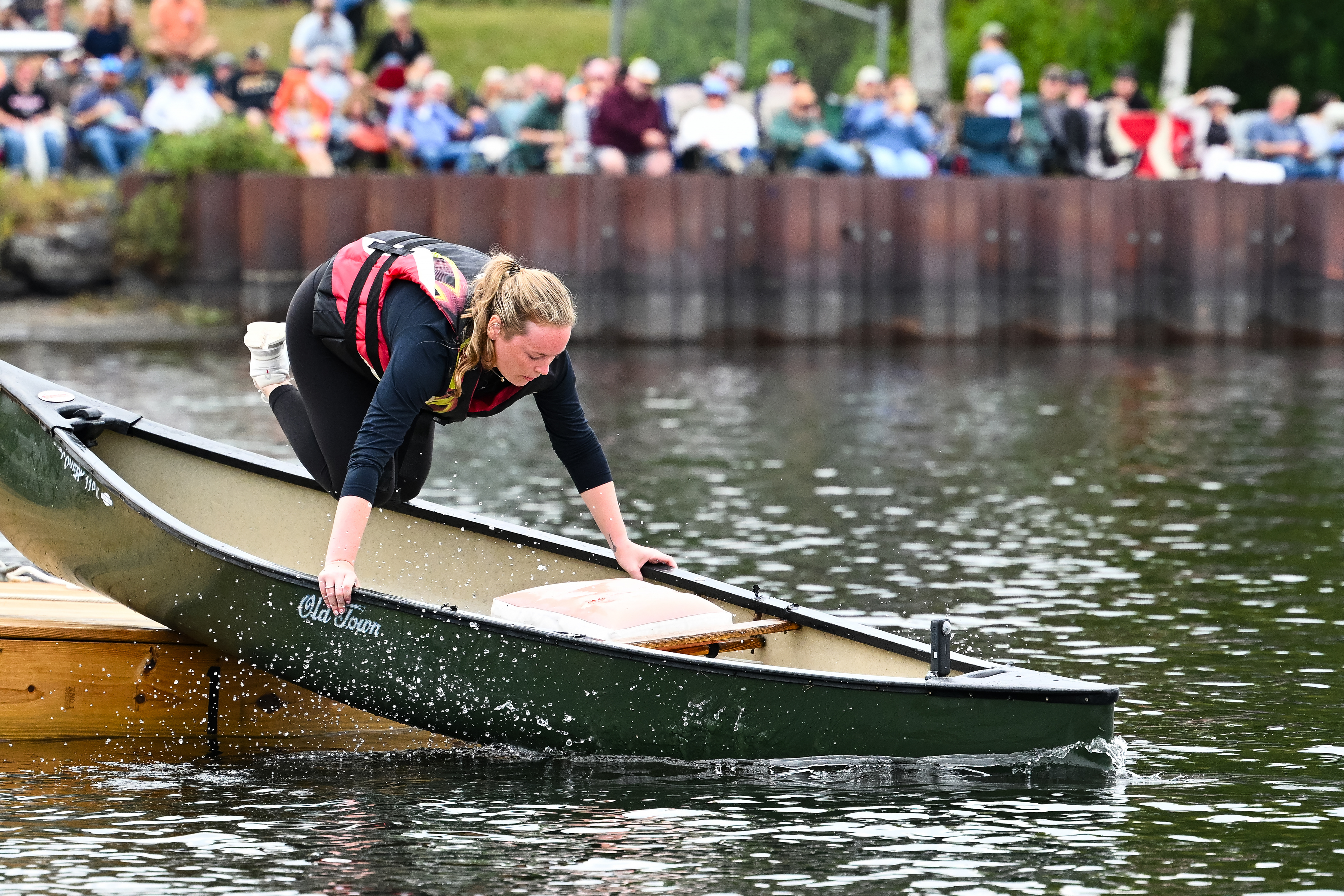 Baily Cust launches an Old Town canoe (made in Maine, naturally) to rendezvous with her uncle, Jeff Hardy, who is simultaneously step-taxiing his 1969 Cessna 180 to a dock for the timed contest. Photo by David Tulis.