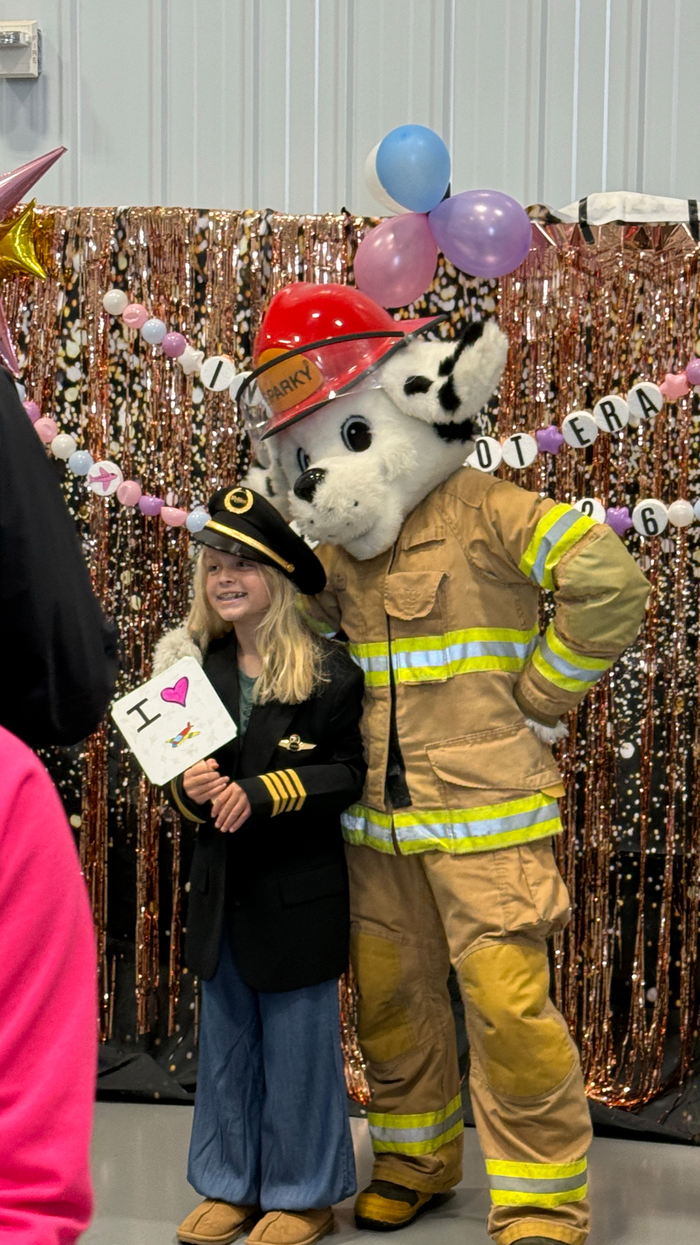 Sparky the Fire Dog poses with a young visitor. Photo by Chris Rose. 