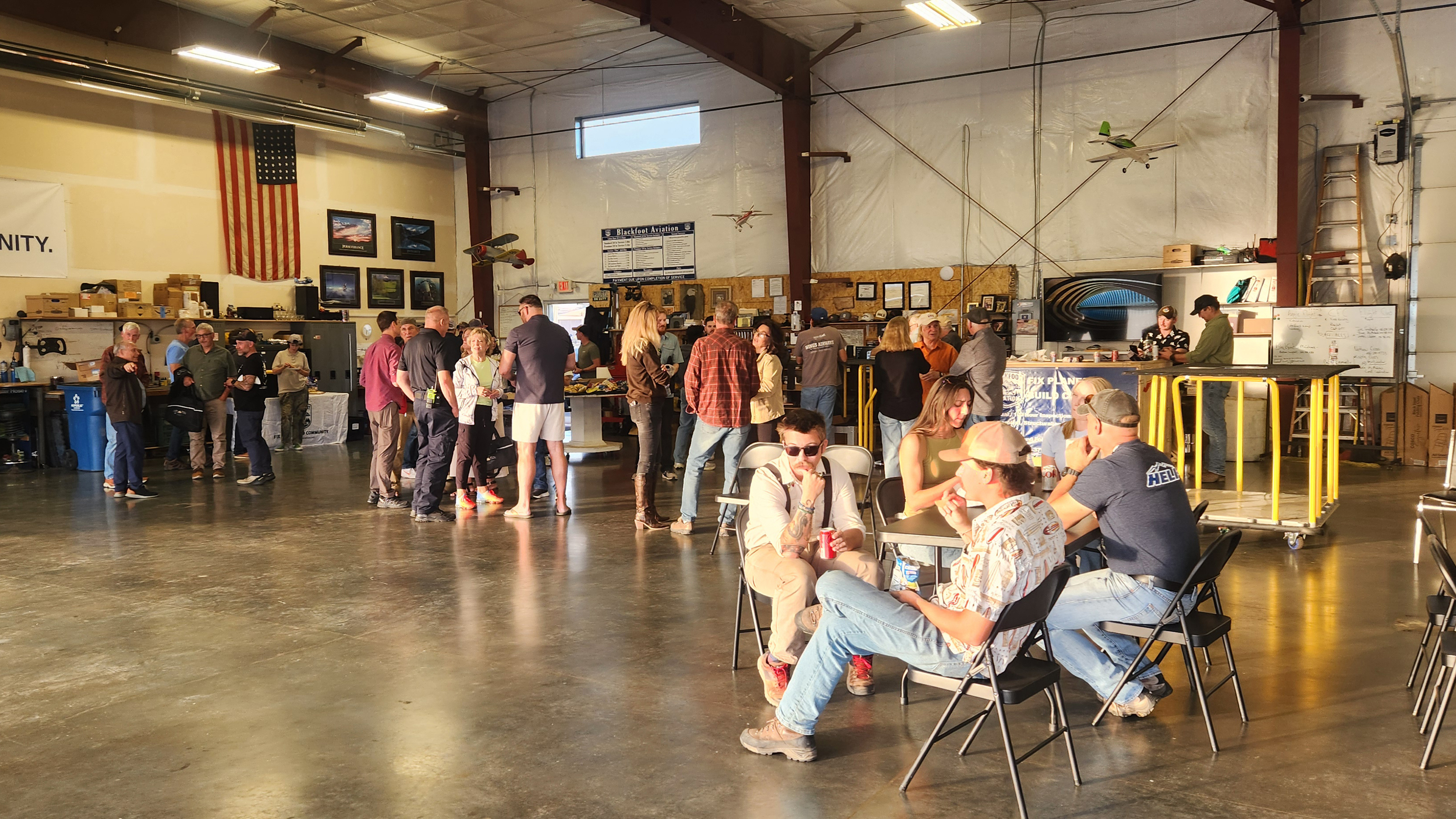 Club members and guests gather in the hangar to enjoy a Montana sunset, good conversation, and the camaraderie that brings the aviation community together. Photo by Katrina Shull.