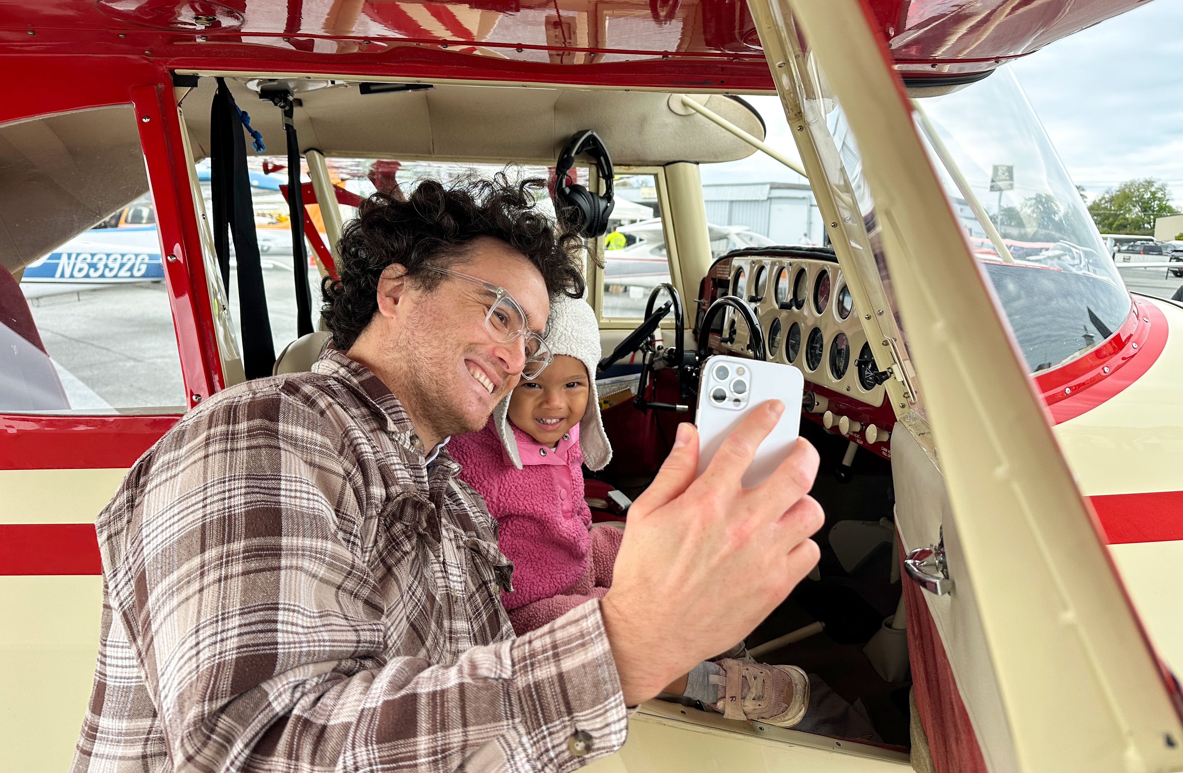 Community residents including parents, children, and aviation enthusiasts congregate at Frederick Municipal Airport for the Festival of Flight where they can see, touch, and experience aviation. Photo by David Tulis.