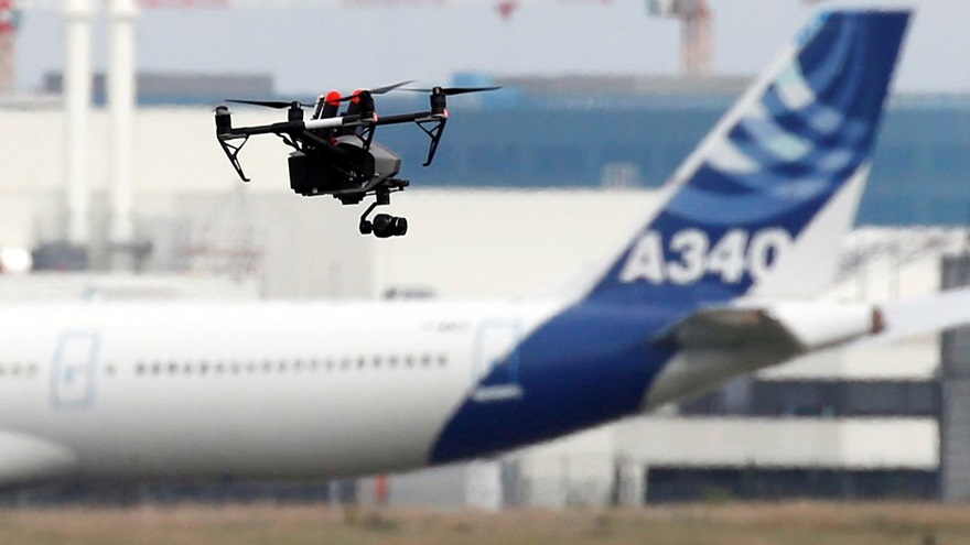 A drone flies near an Airbus A340 aircraft in Colomiers near Toulouse, France, Oct. 19, 2017. Photo by Regis Duvignau, REUTERS.