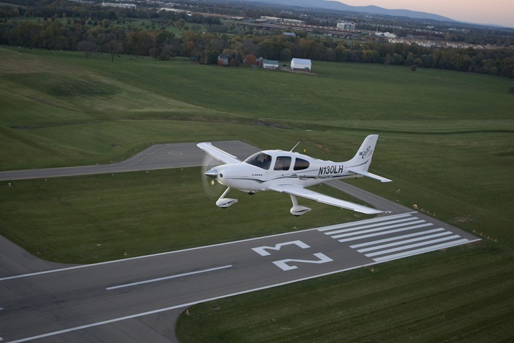 A Cirrus SR22 GTS flies near a runway in Maryland. Photo by Chris Rose.