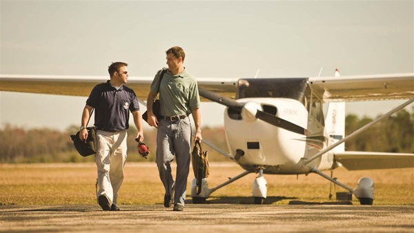 A student and instructor talking while walking to their Cessna 172 at Sterling Flight Center.Jacksonville, FL   United StatesImage#: 06-486_0277.jpg     Camera: Canon EOS-1Ds Mark II http://mikefizer.com    mike@mikefizer.com