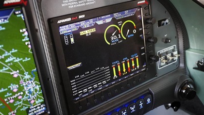 The left primary flight display shows flight information (with synthetic vision), the center display is a moving map, and the right primary flight display acts as an engine monitor.
