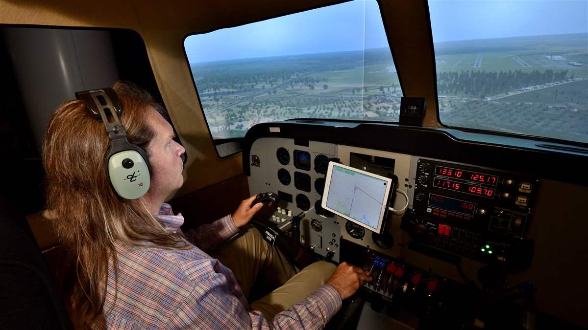 Matthew Pollack, who heads MITRE’s Digital Co-Pilot project, uses the software to fly a simulated approach to Manassas, Virginia. His team has tested the software in flight, as well.