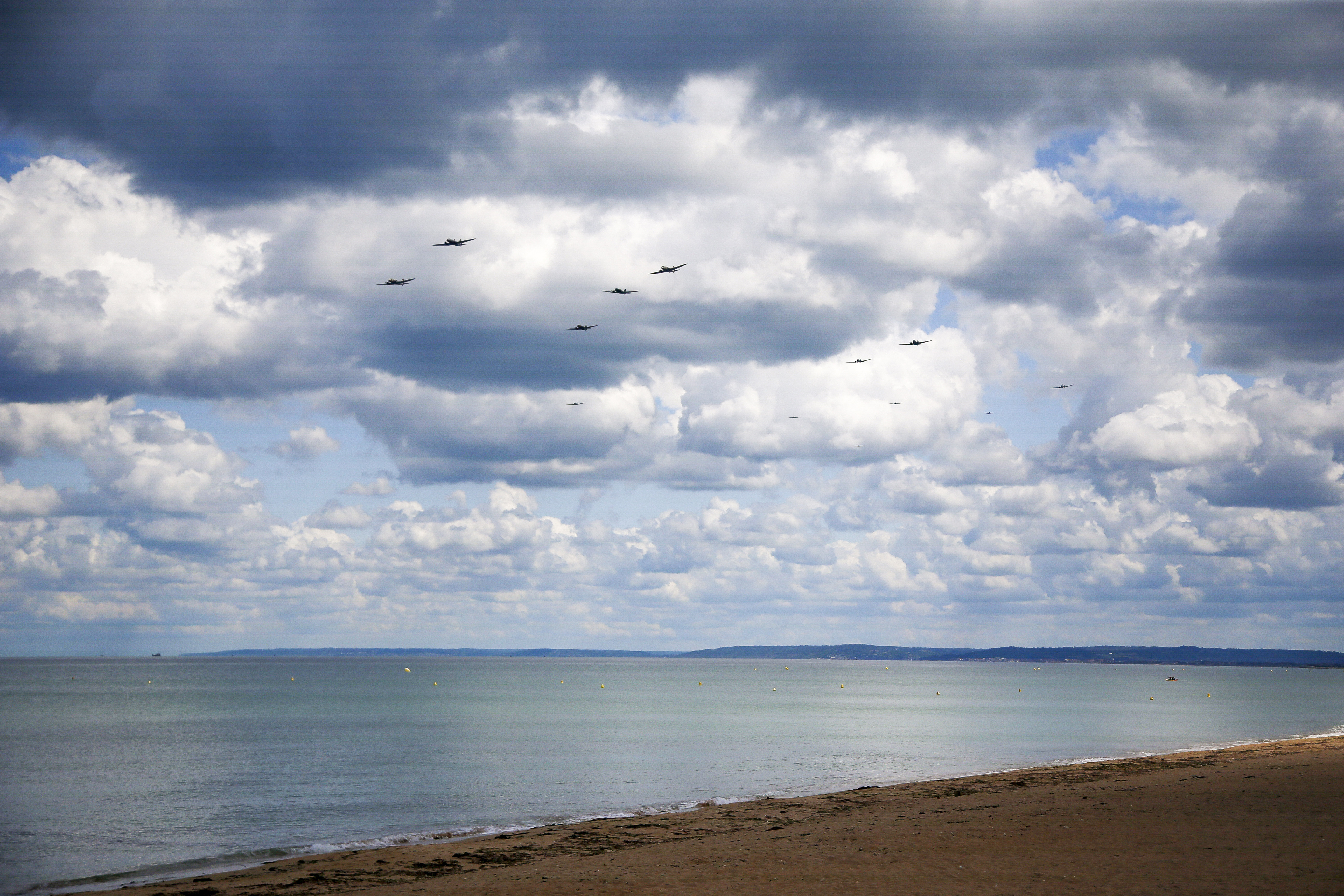 A formation of C-47s and DC-3s prowl Sword beach on the 75th anniversary of D-Day.