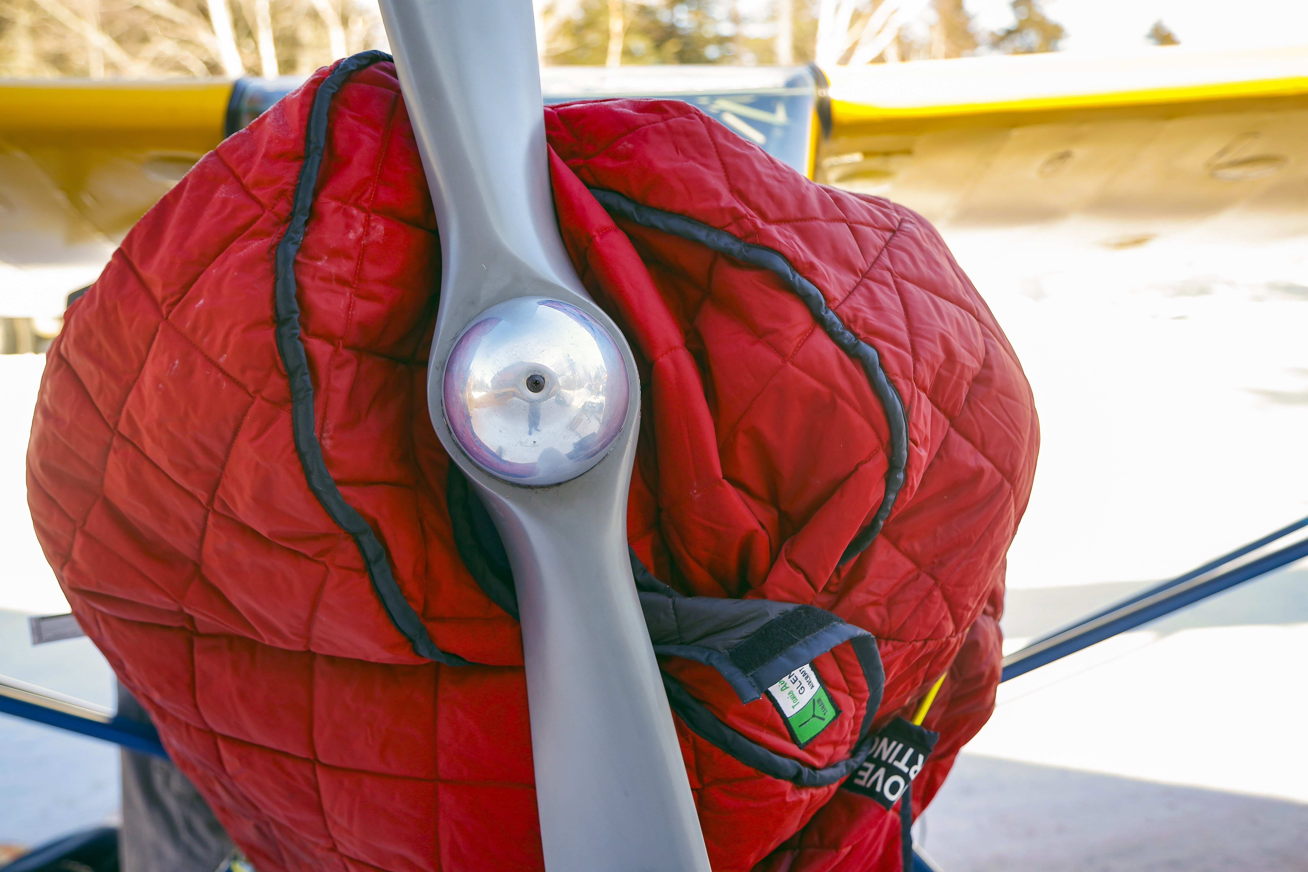 A quilted engine cover preserves heat in the engine compartment for the next start. A metal prop typically gets covered, too, to prevent transferring cold temperatures to the engine block.